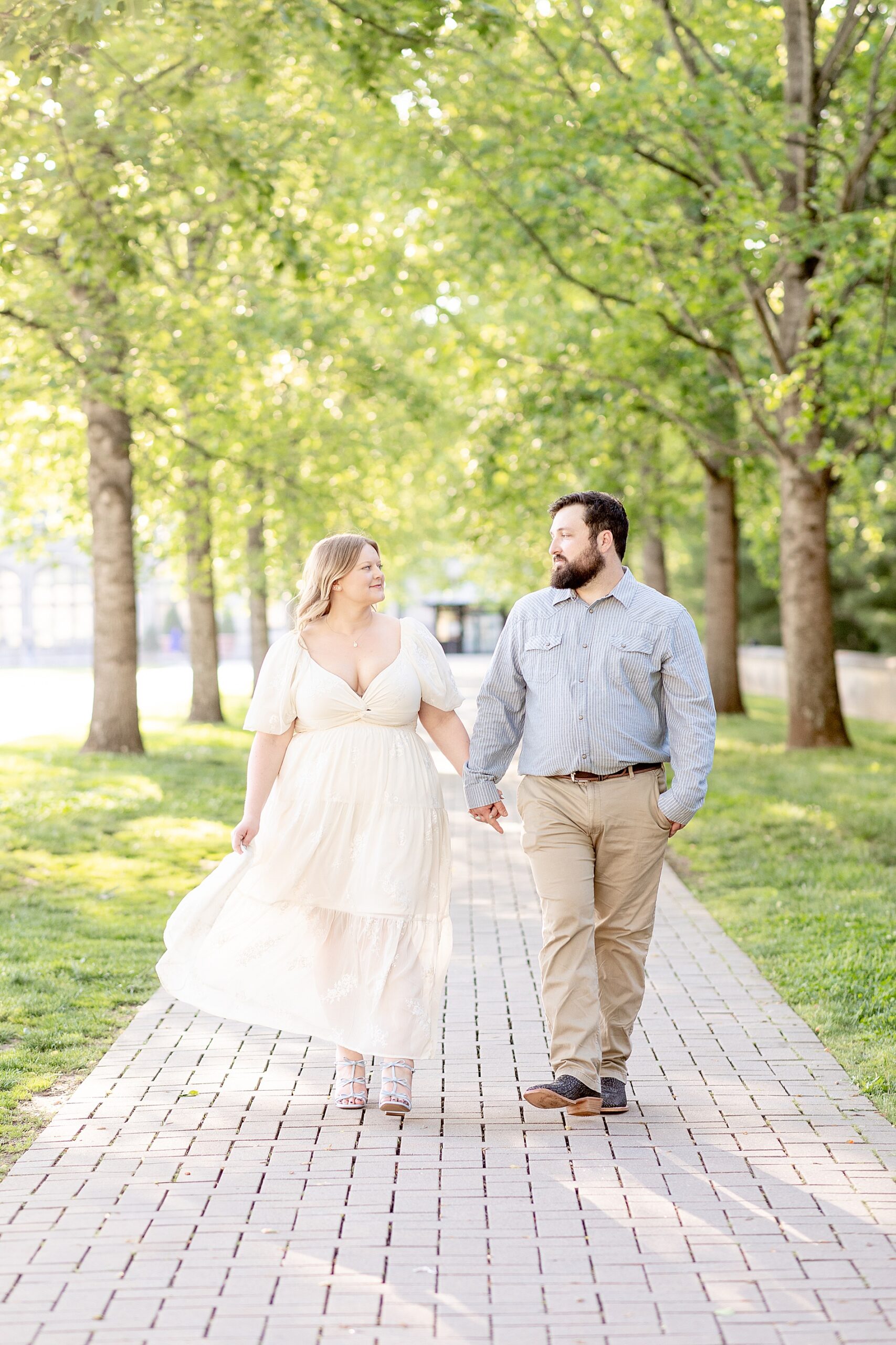 couple hold hands during spring engagement at Biltmore Estate Engagement