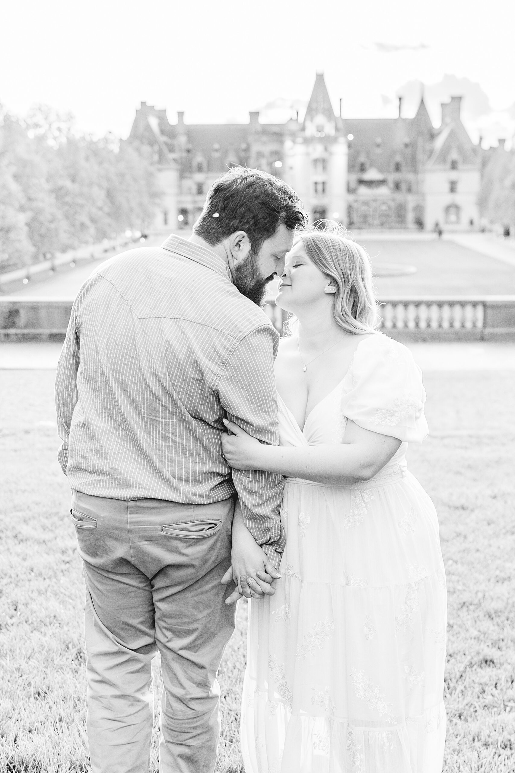 black and white photo of couple in front of estate