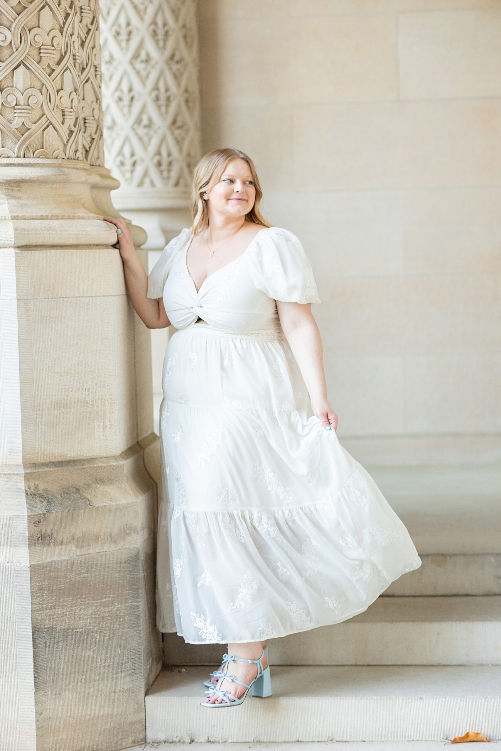 woman stands by pillar