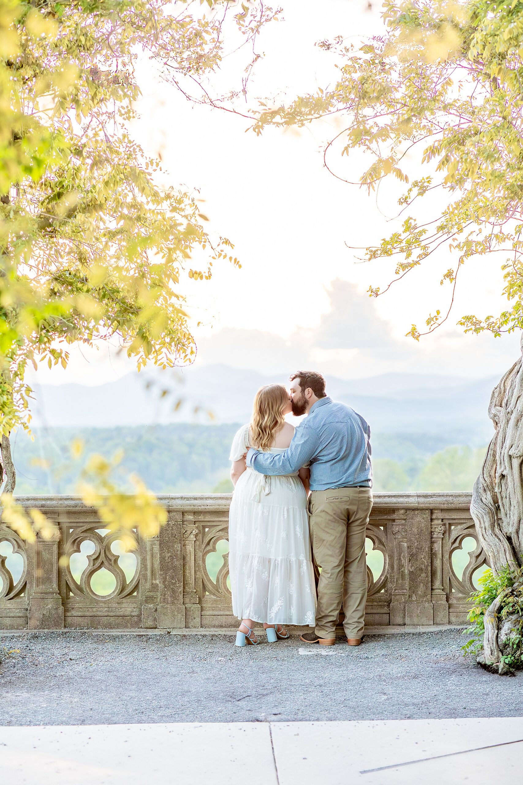couple kiss during spring engagement