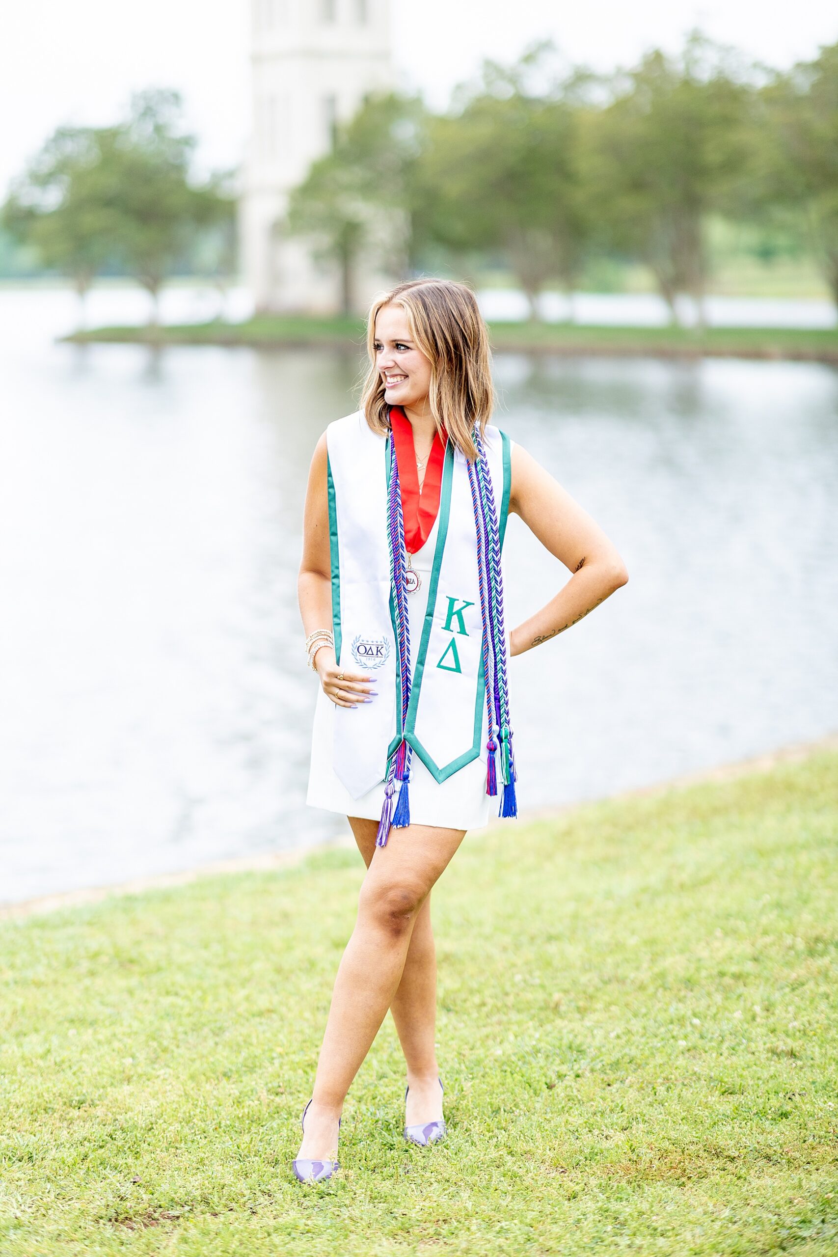 college grad stands by lake at Furman University