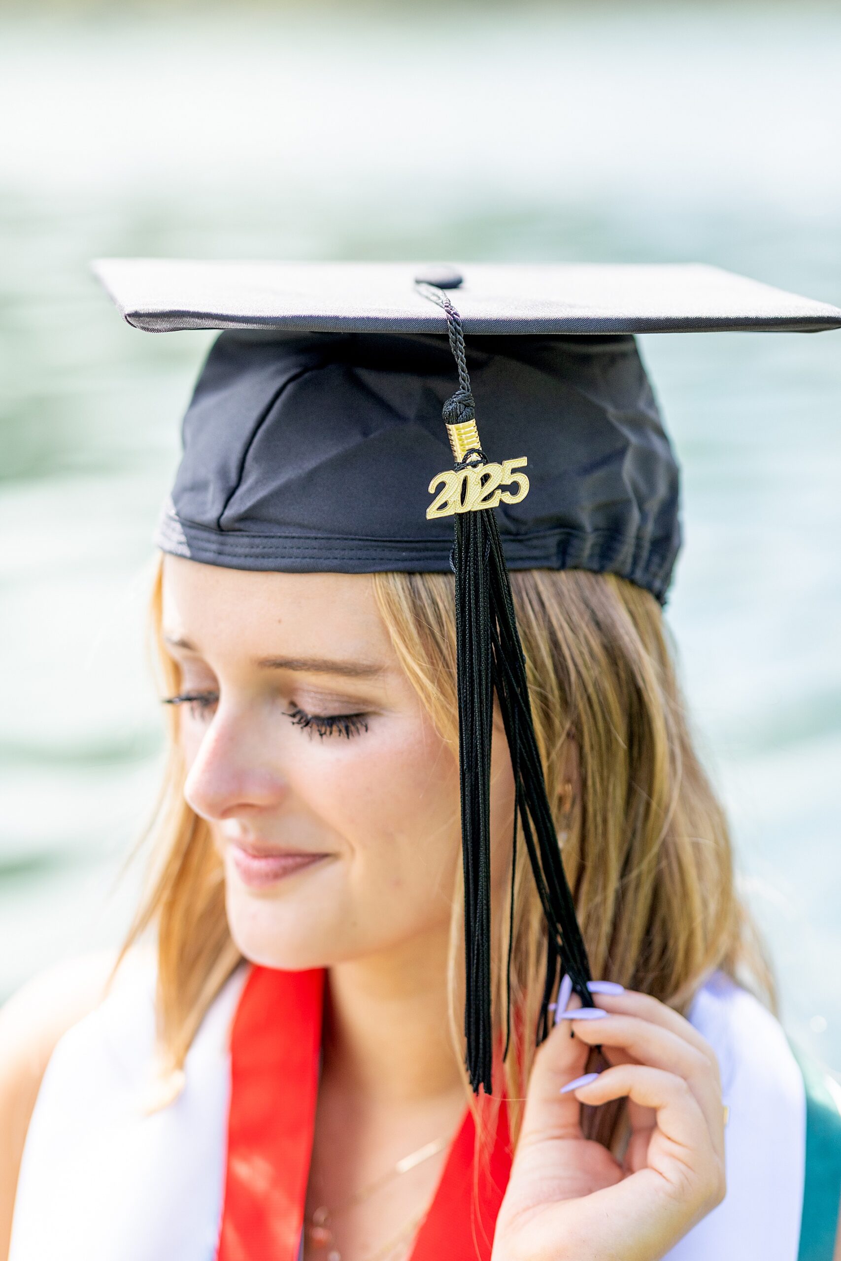 college grad holds cap tassle