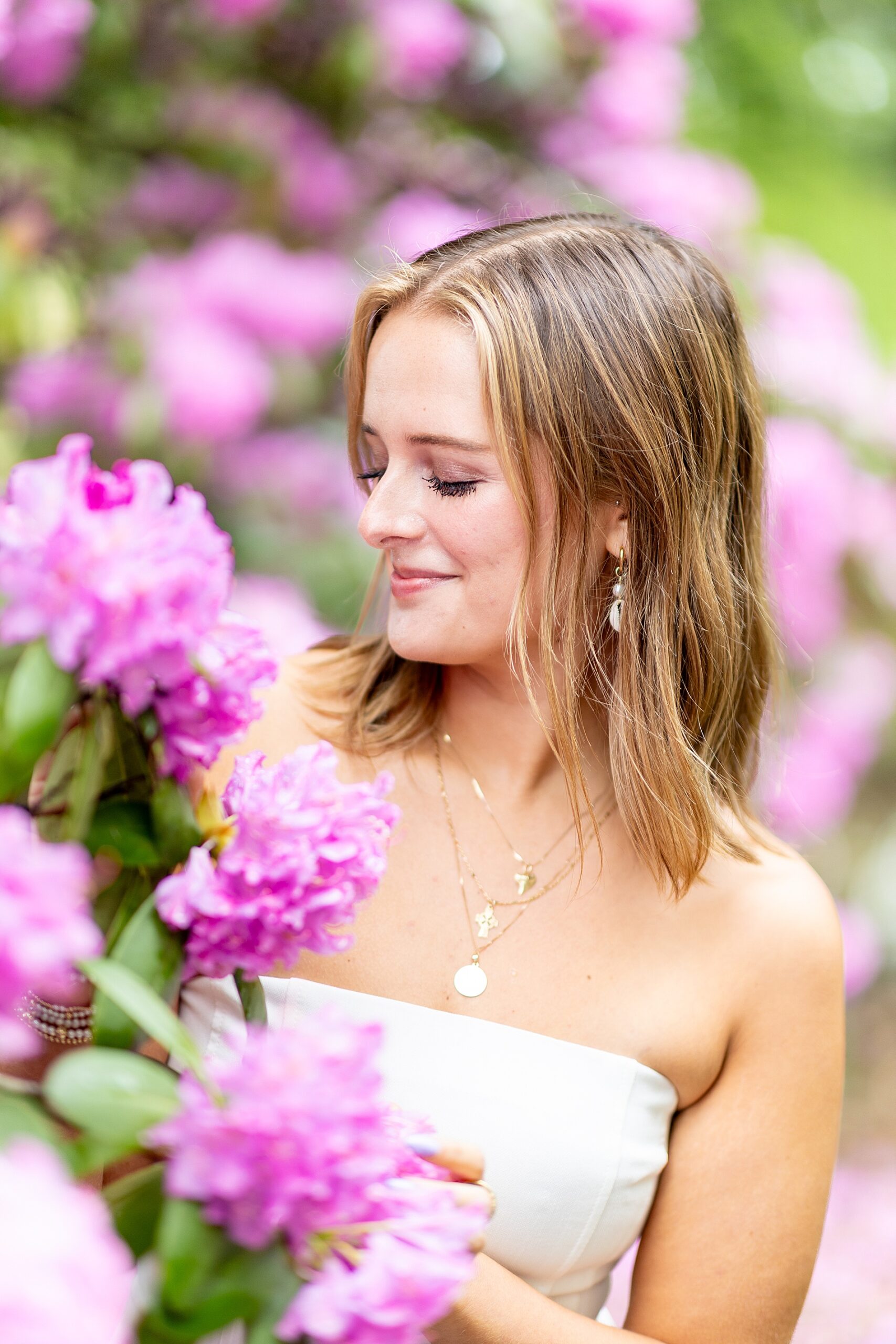 woman smells pink flowers