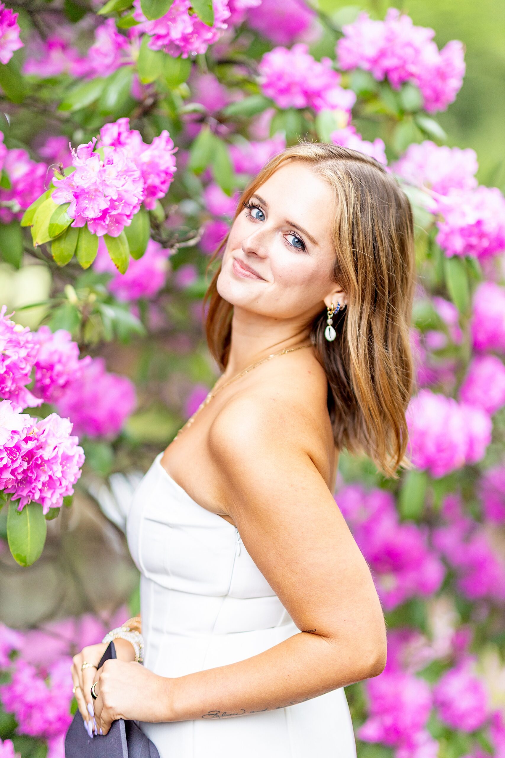pink flowers surround college grad