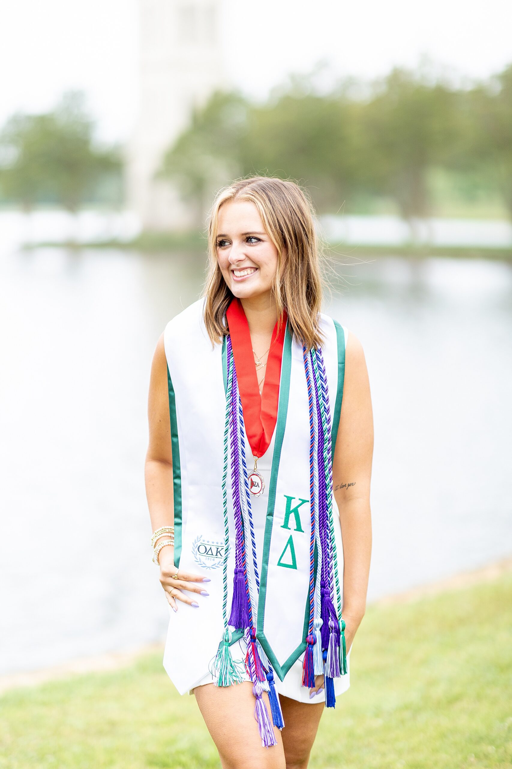 college senior wears all her honors and cords from her department