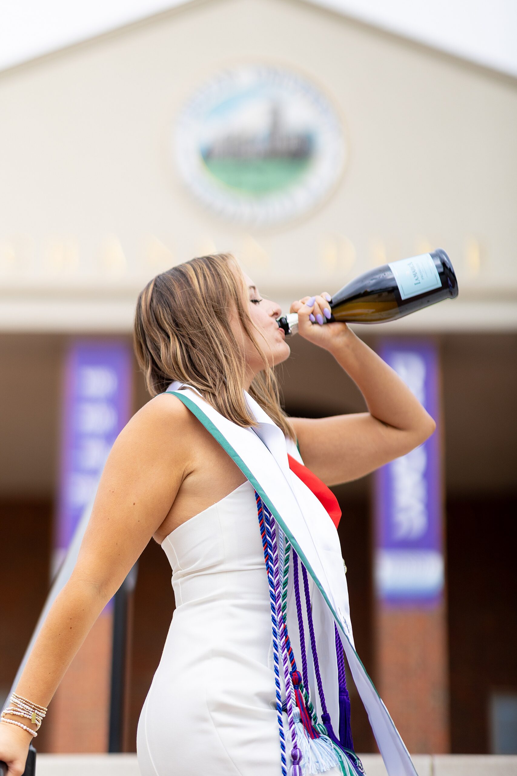 college grad drinks champagne