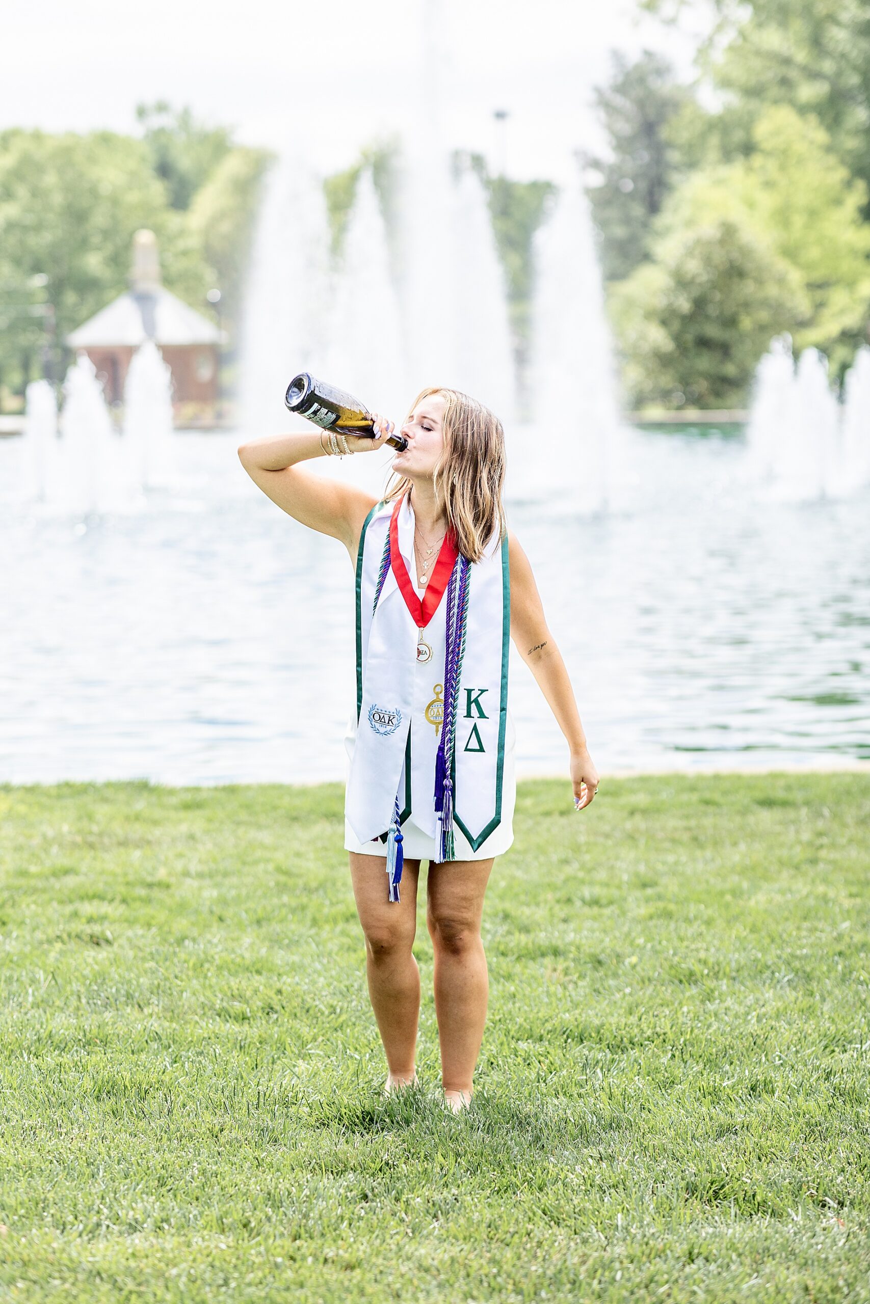 graduating senior at Furman University drinks champagne to celebrate
