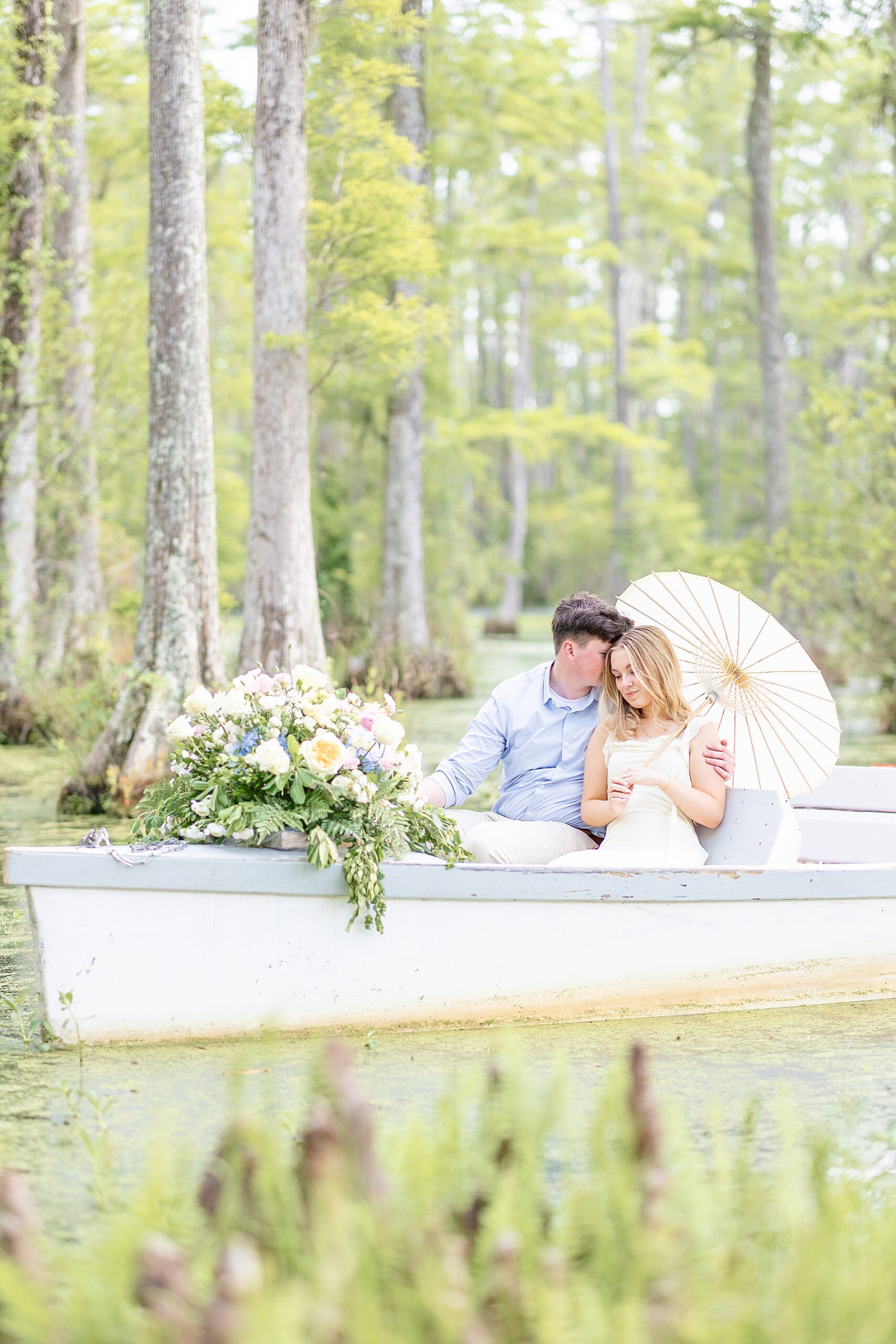 Cypress Garden engagement photos of couple floating on boat