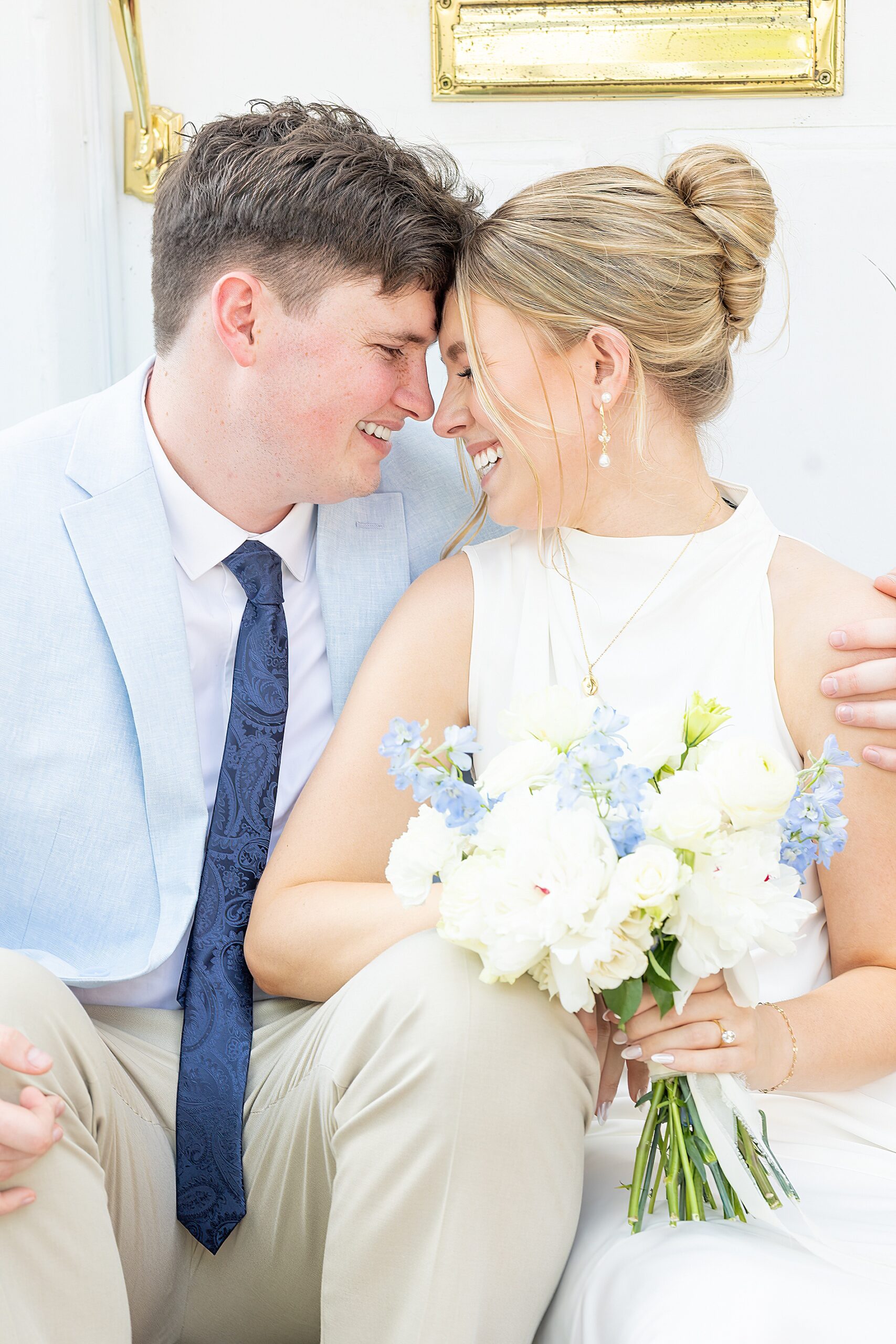 engaged couple lean in to each other