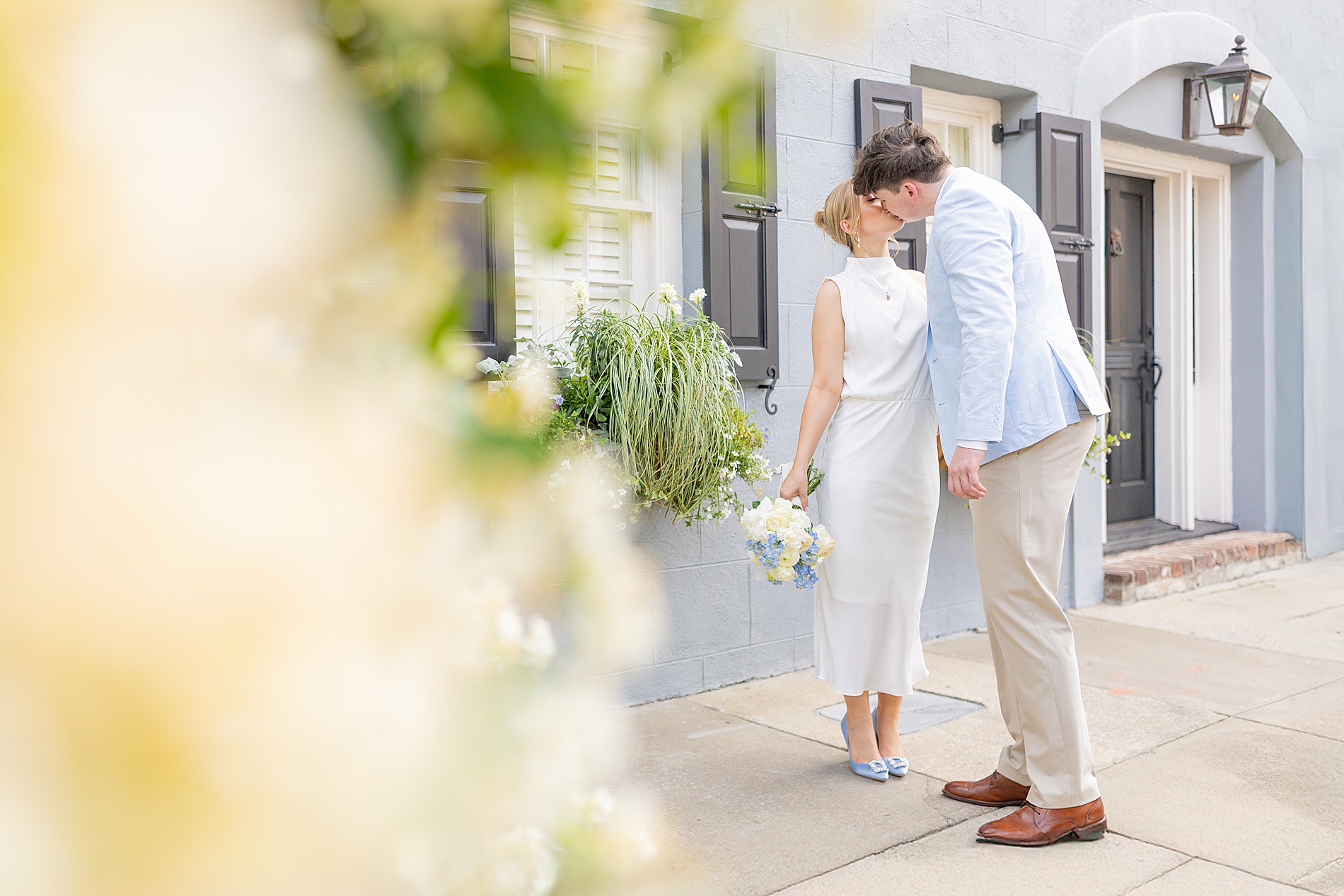 couple kiss on sidewalk of Charleston street
