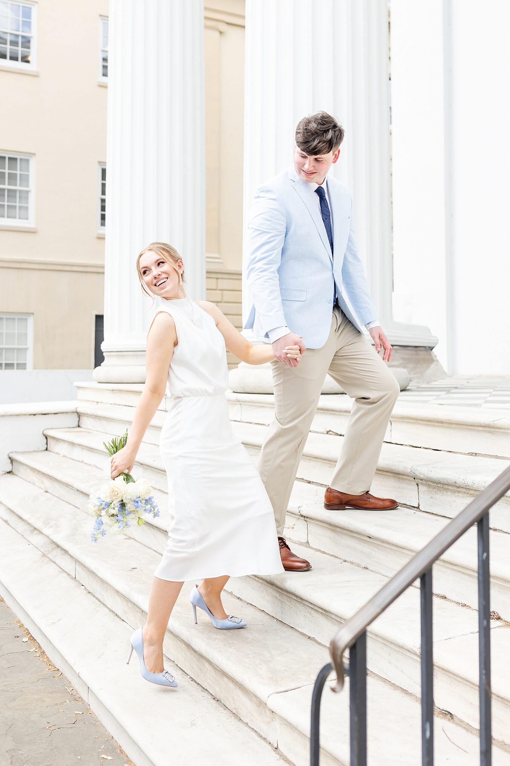 Romantic engagement photos of couple walking up steps of building