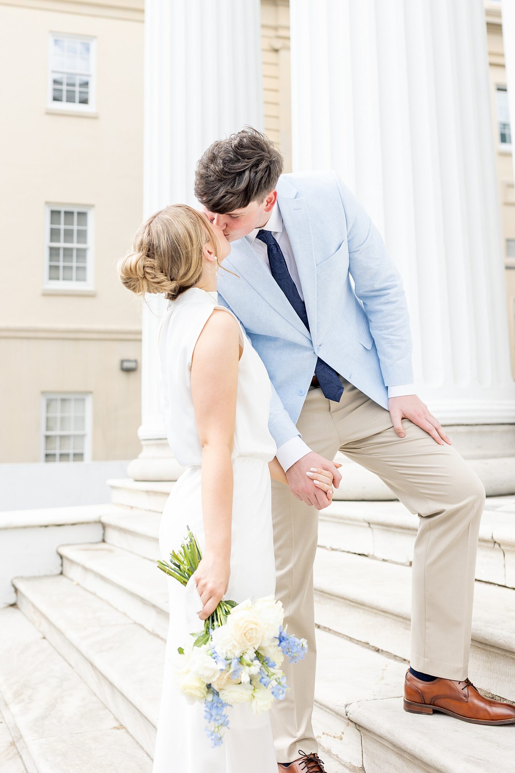 couple kiss on stairs to building
