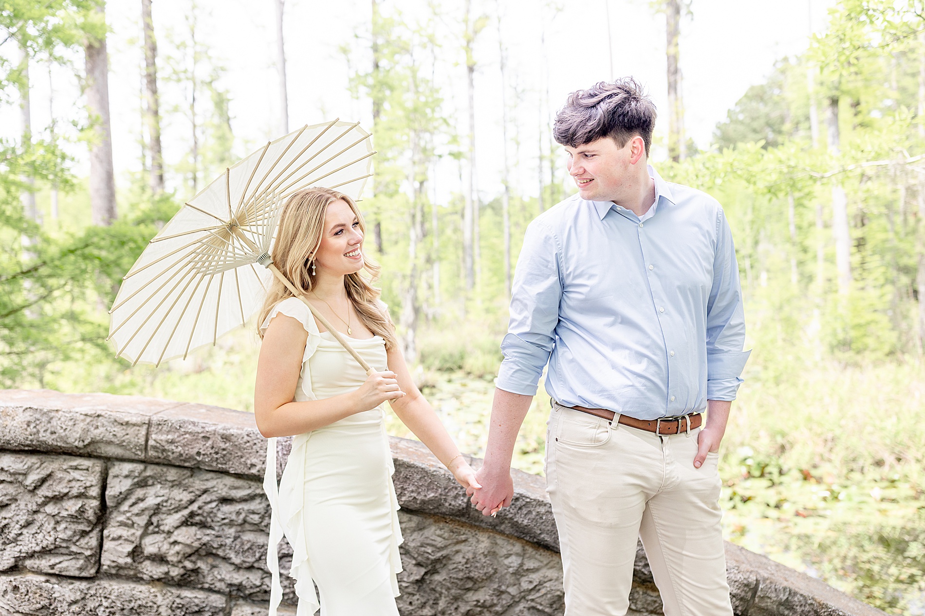 engaged couple walk together holding hands