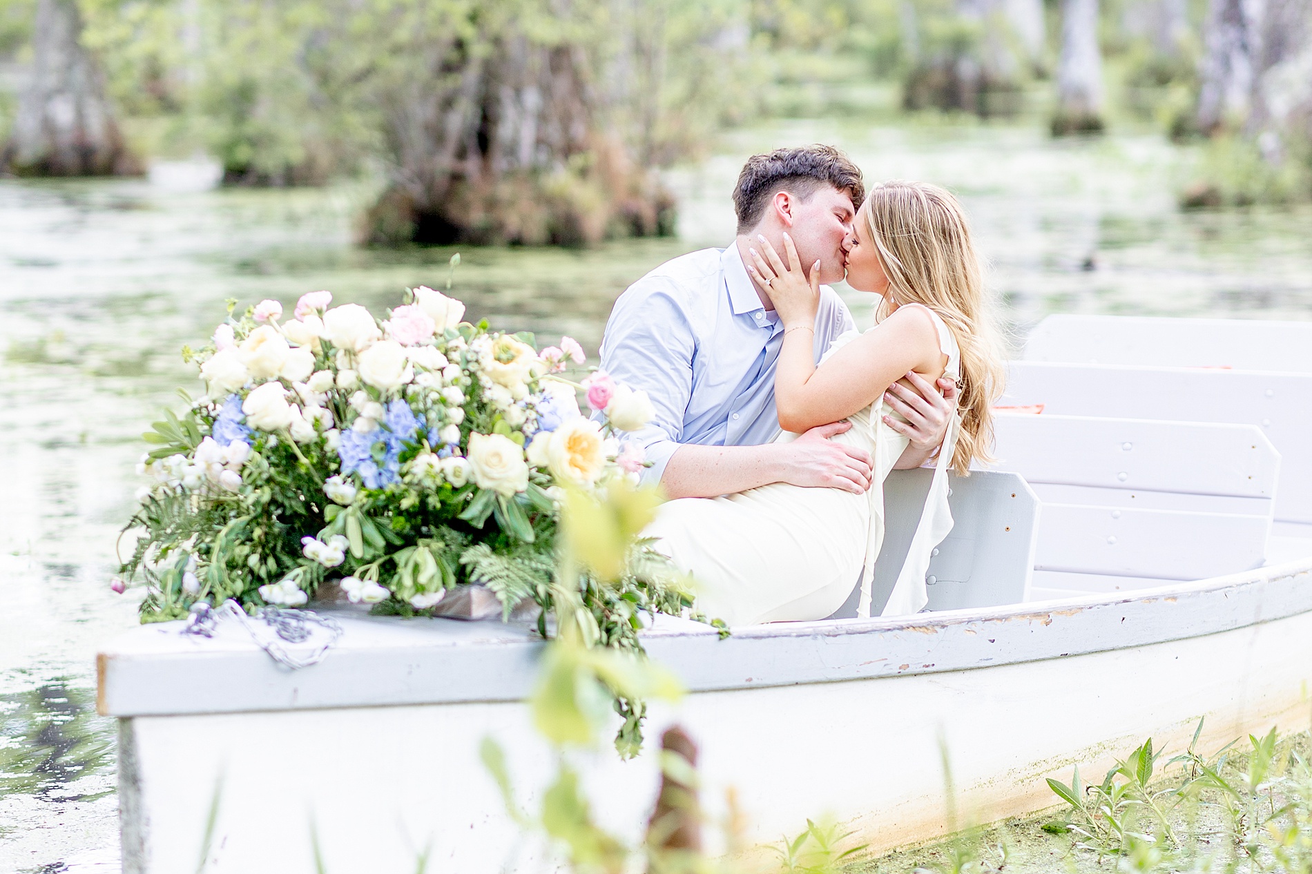 couple kiss in boat in Cypress Gardens
