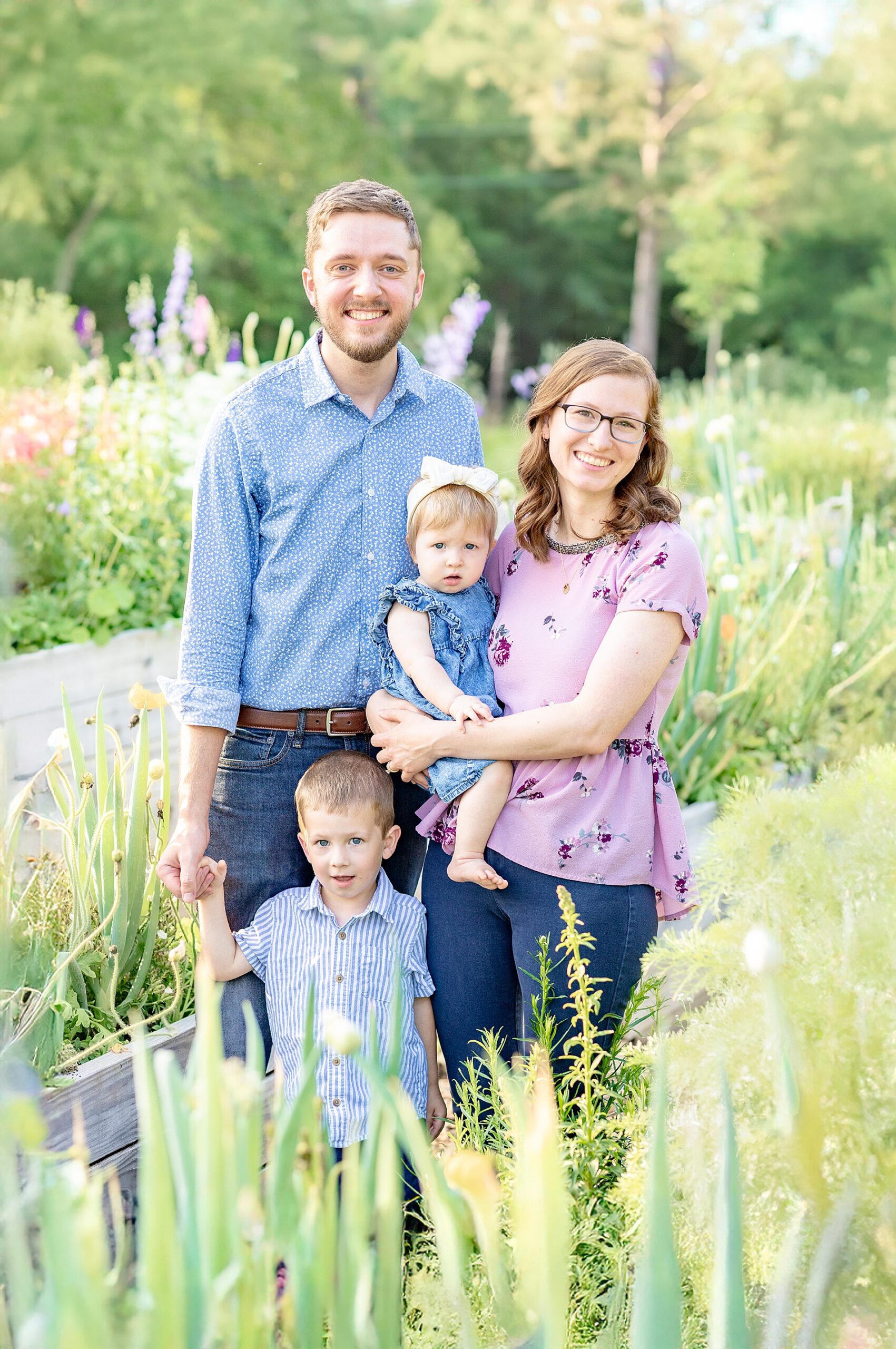 family of four surrounded by fresh blooms during spring mini sessions