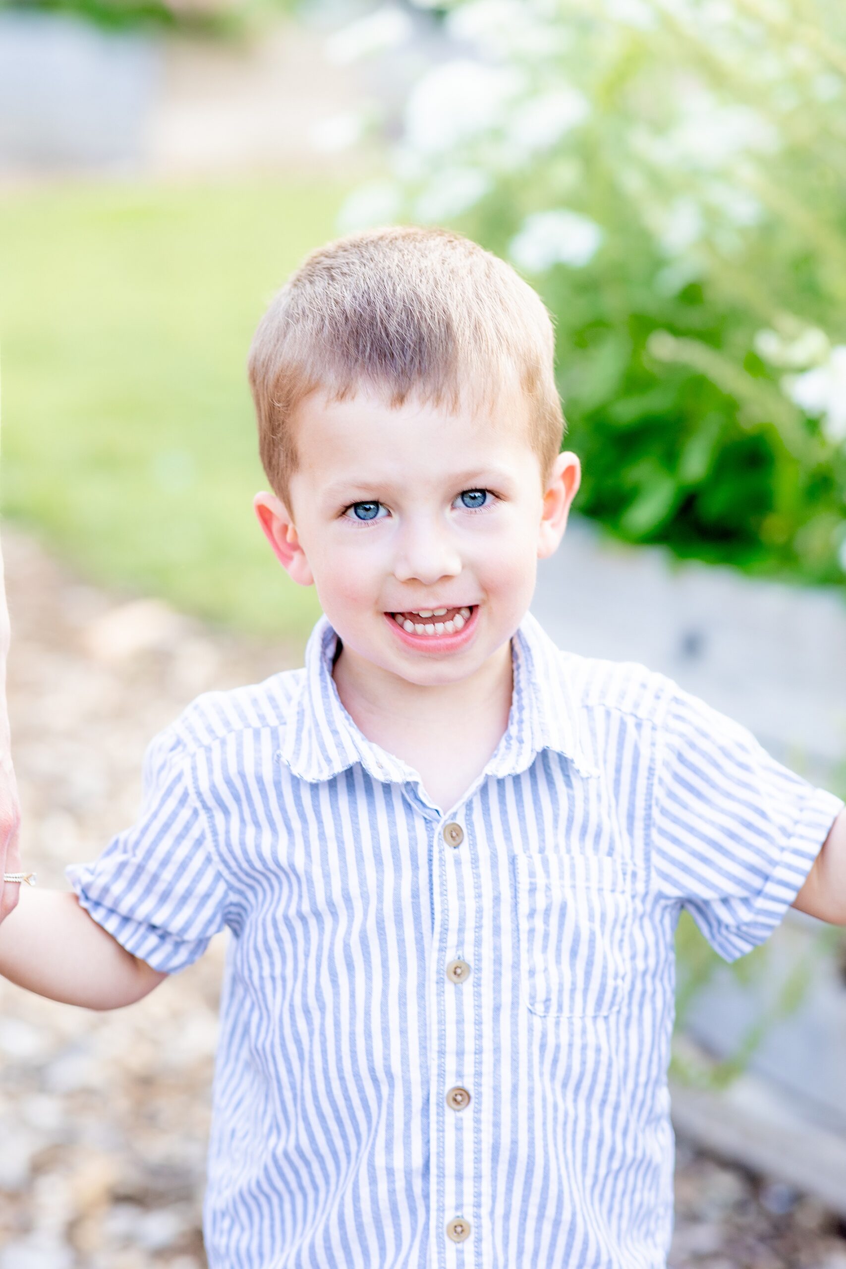 little boy in blue and white striped shirt
