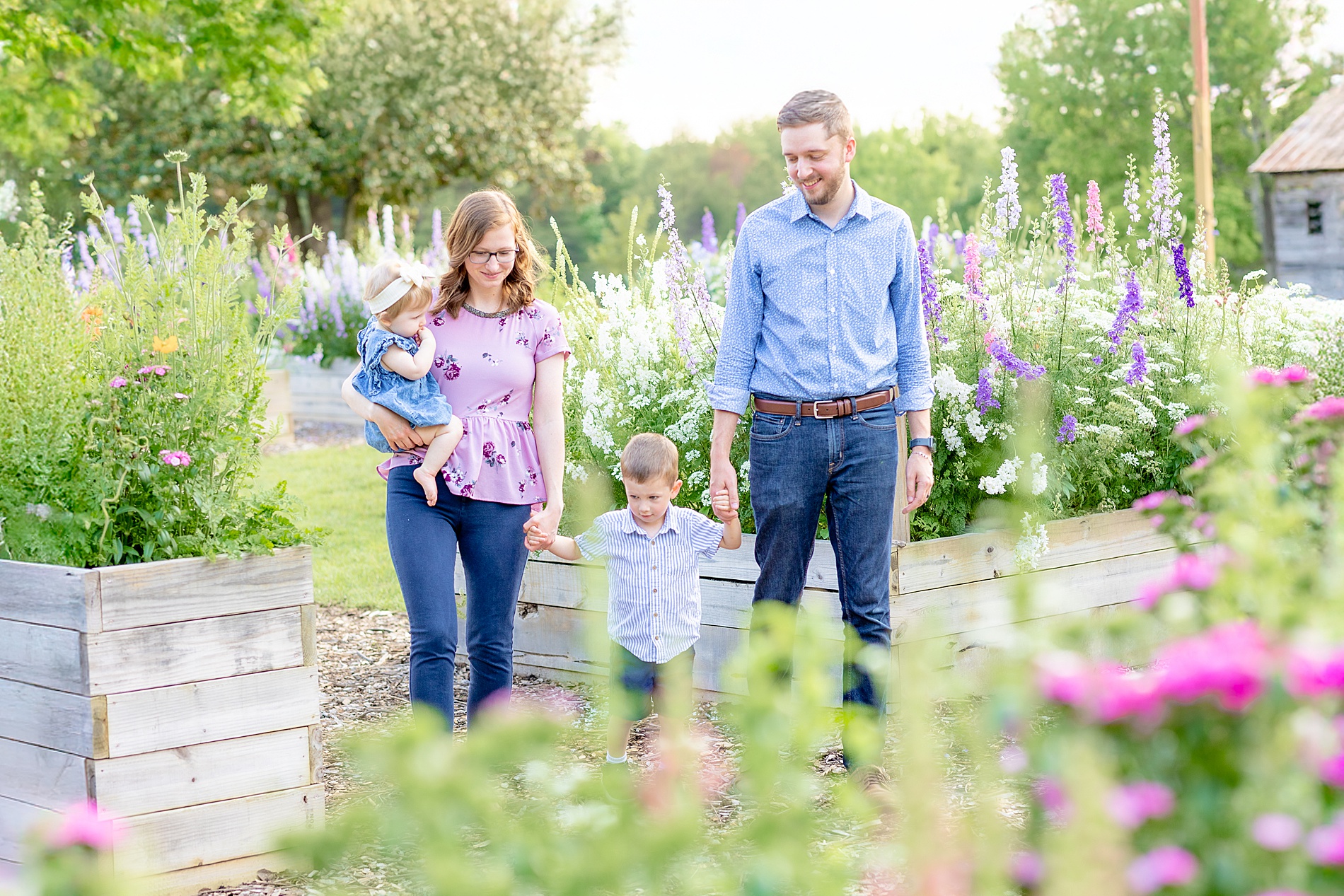 parents walk with their two kids at Rabbit Crest Farms