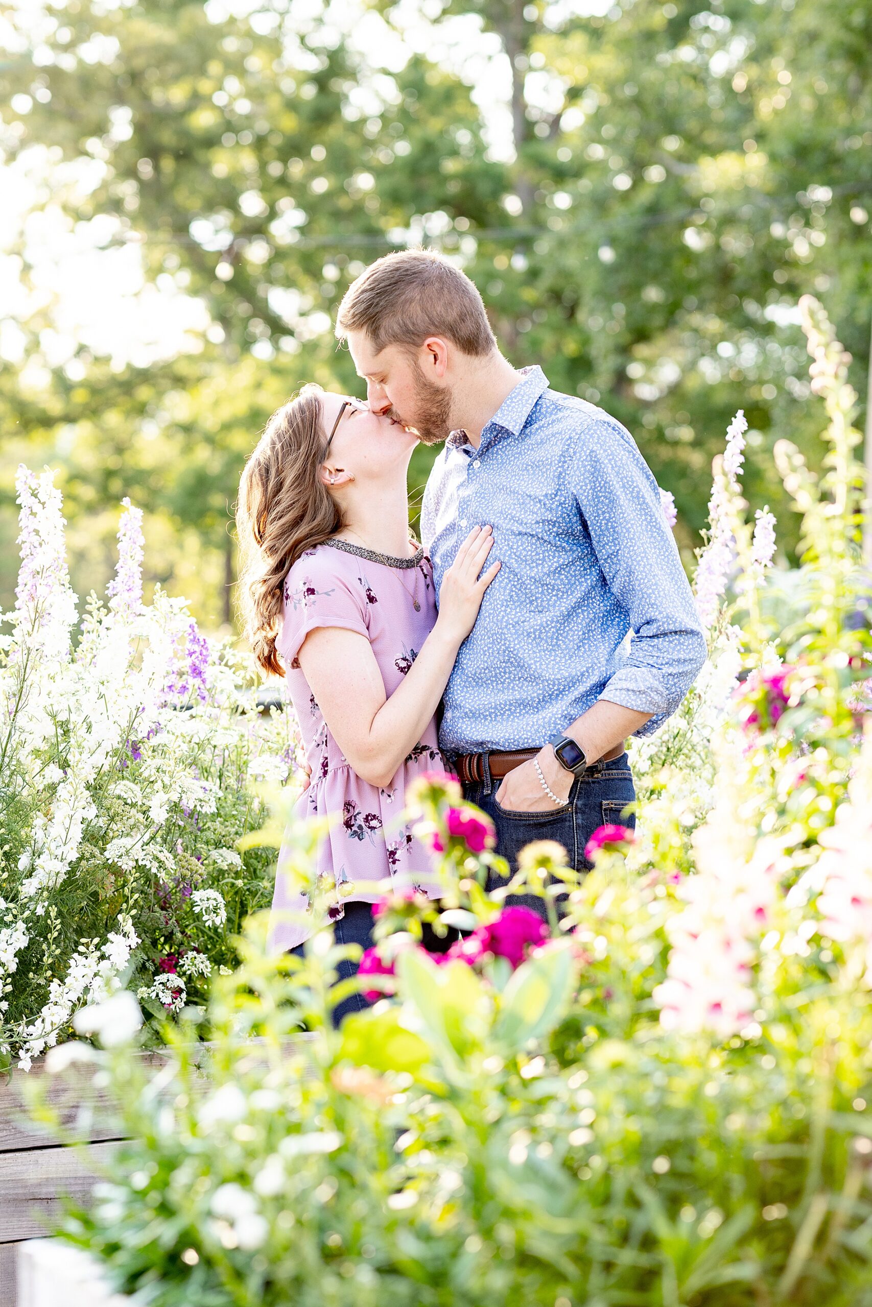 couple kiss surrounded by spring blooms