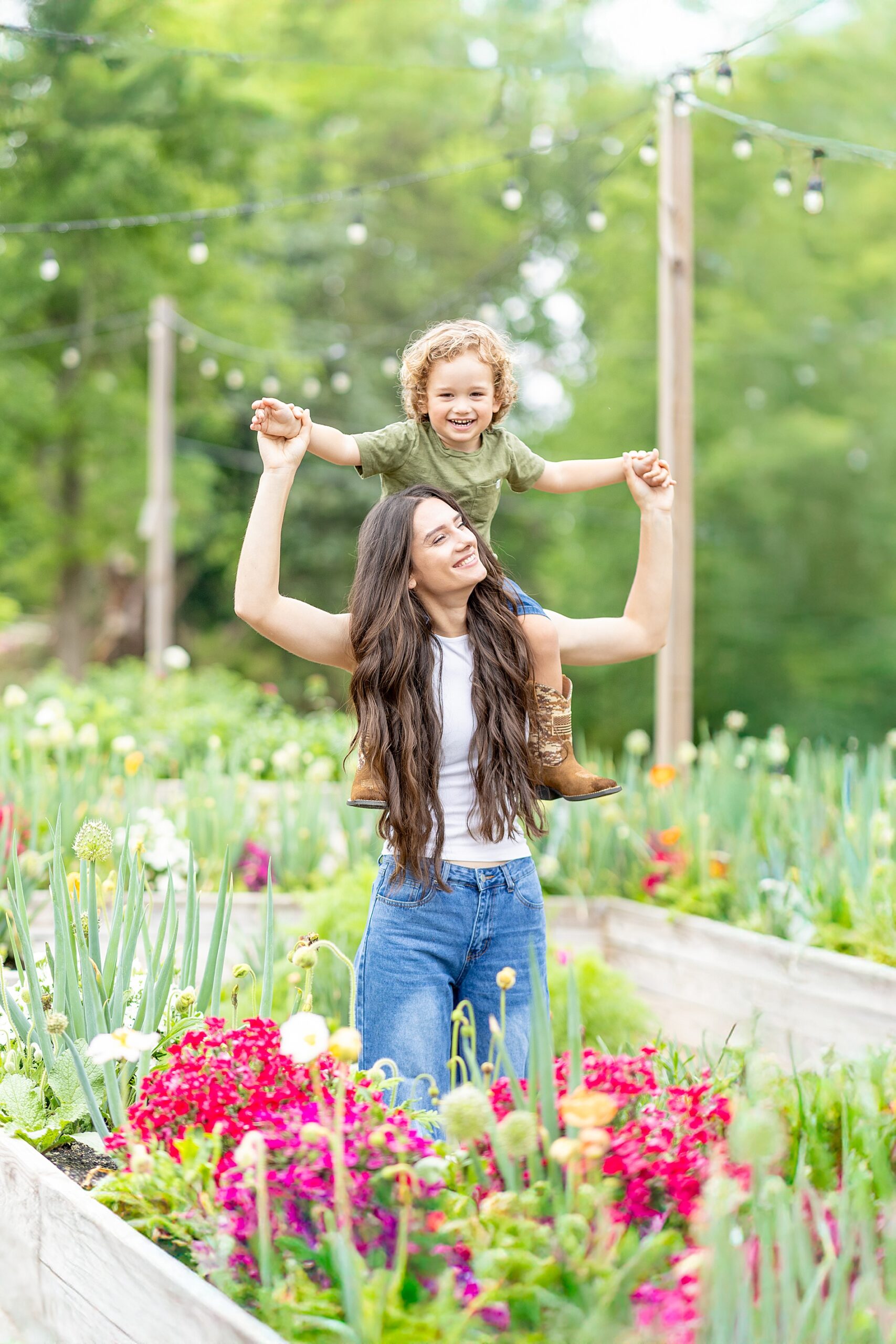 candid family photos of mom carrying son on shoulders