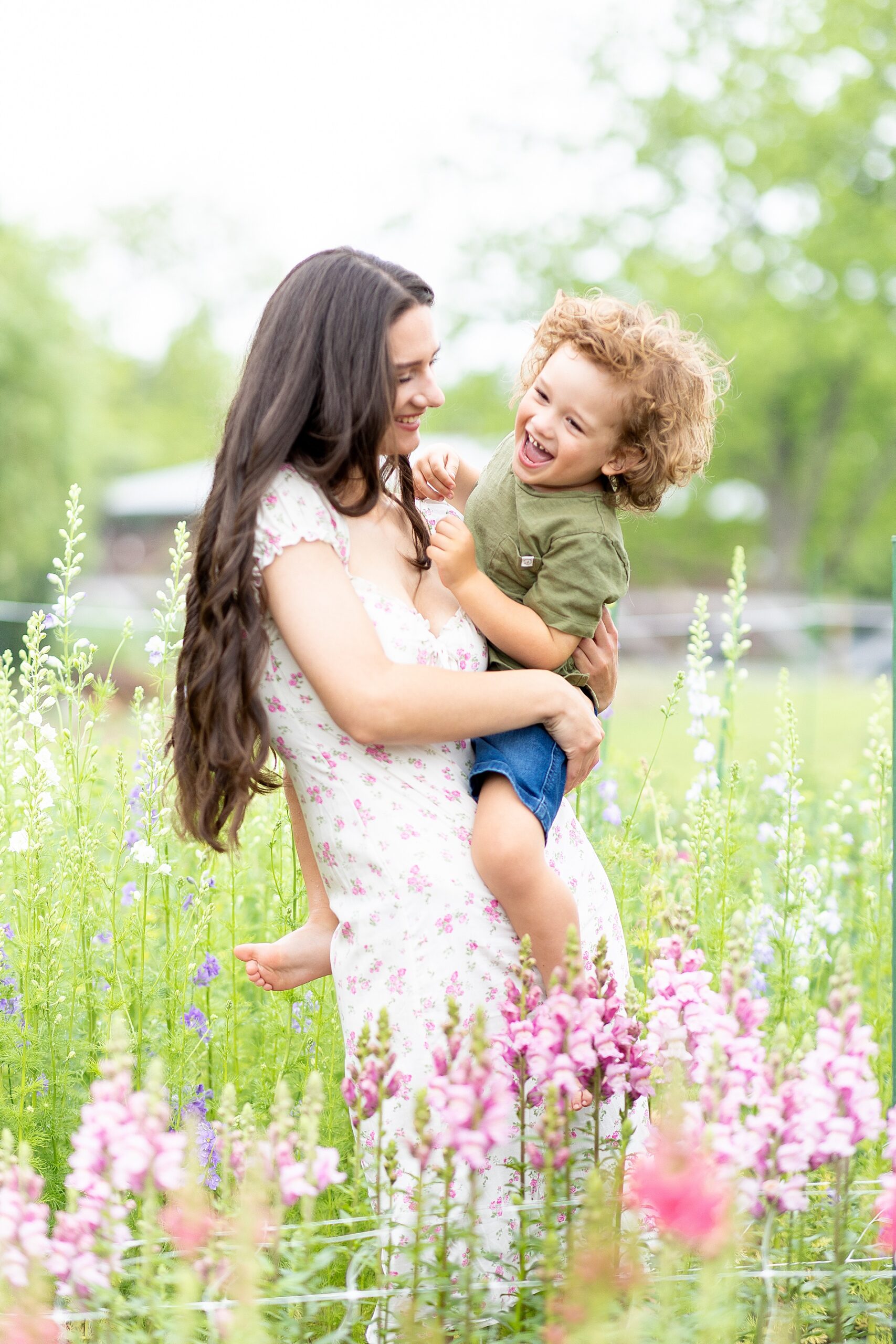 mom holds son as he laughs