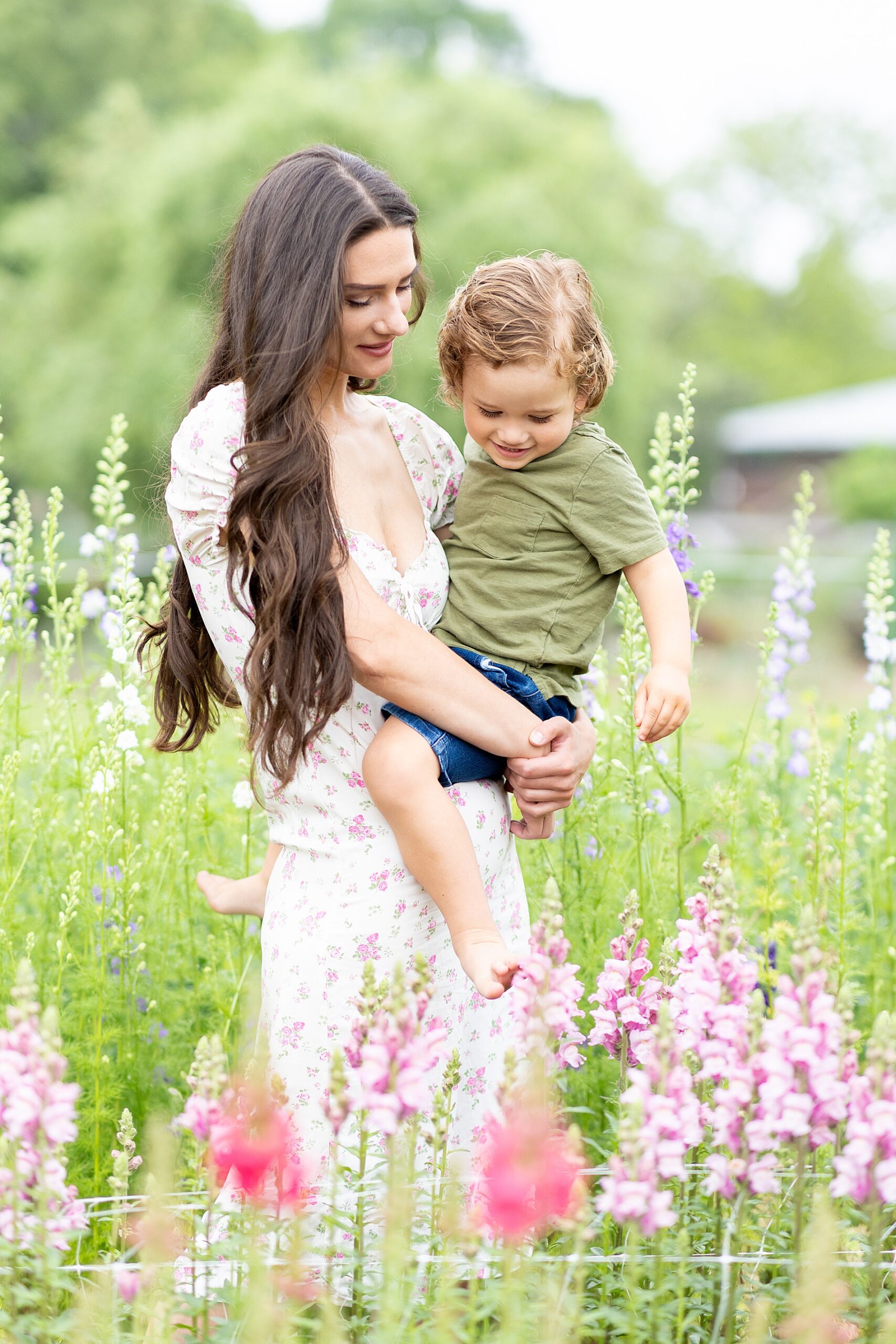 mother and son in field of pink flowers during spring mini session