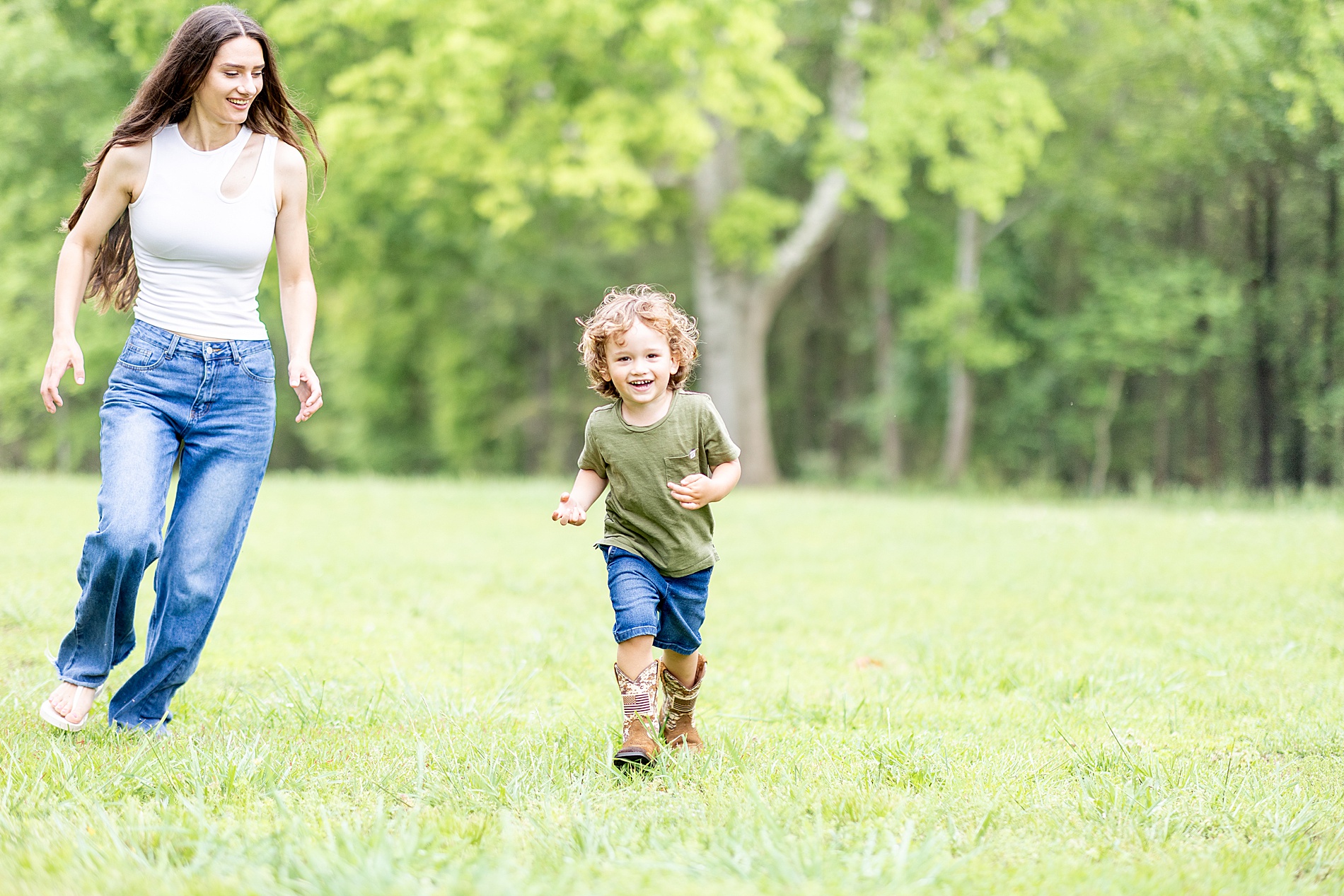 mom and son run in field playing during Spring Mini Sessions in Greenville, SC at Rabbit Crest Farms