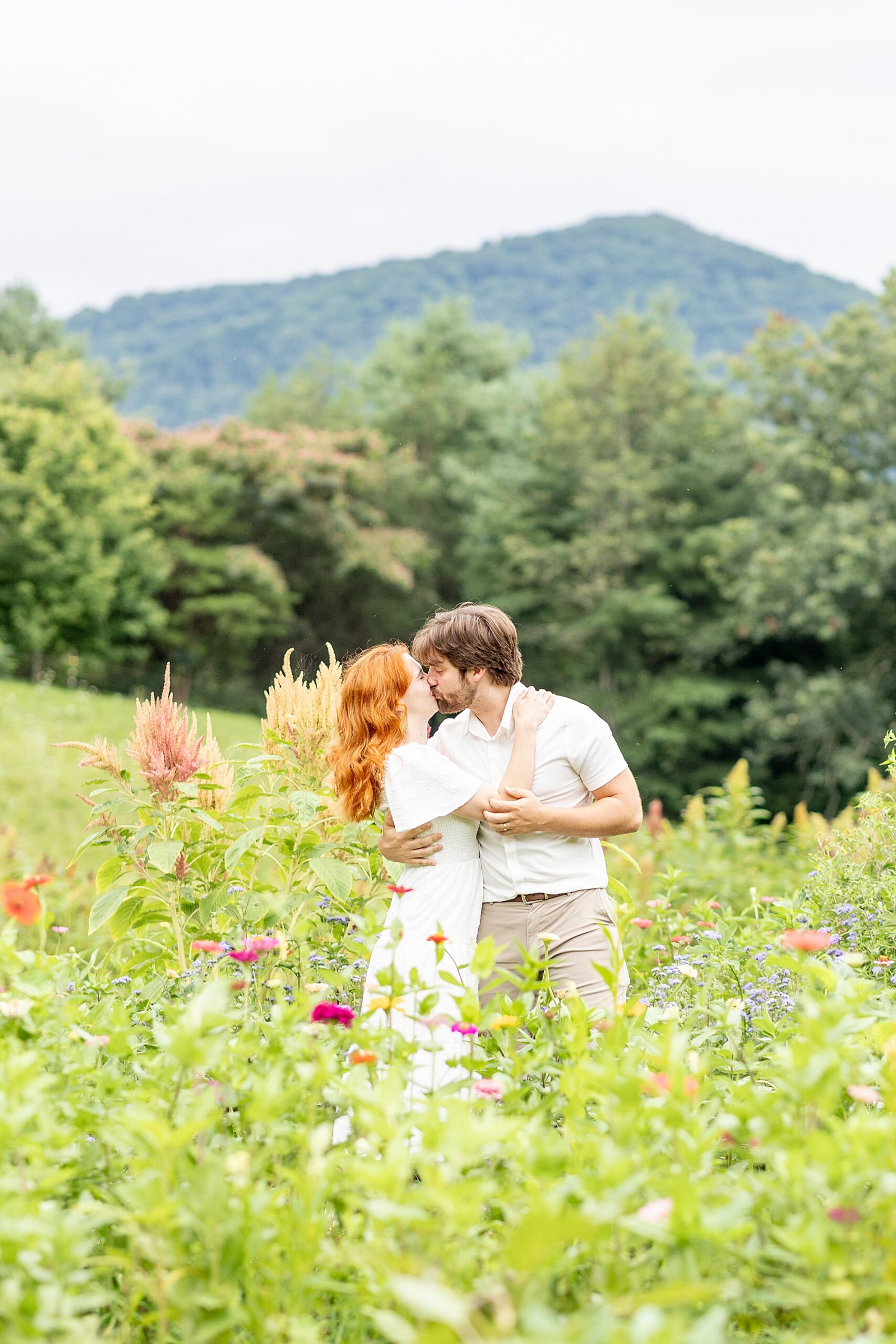 couple kiss at The Never Ending Flower Farm in Asheville, NC