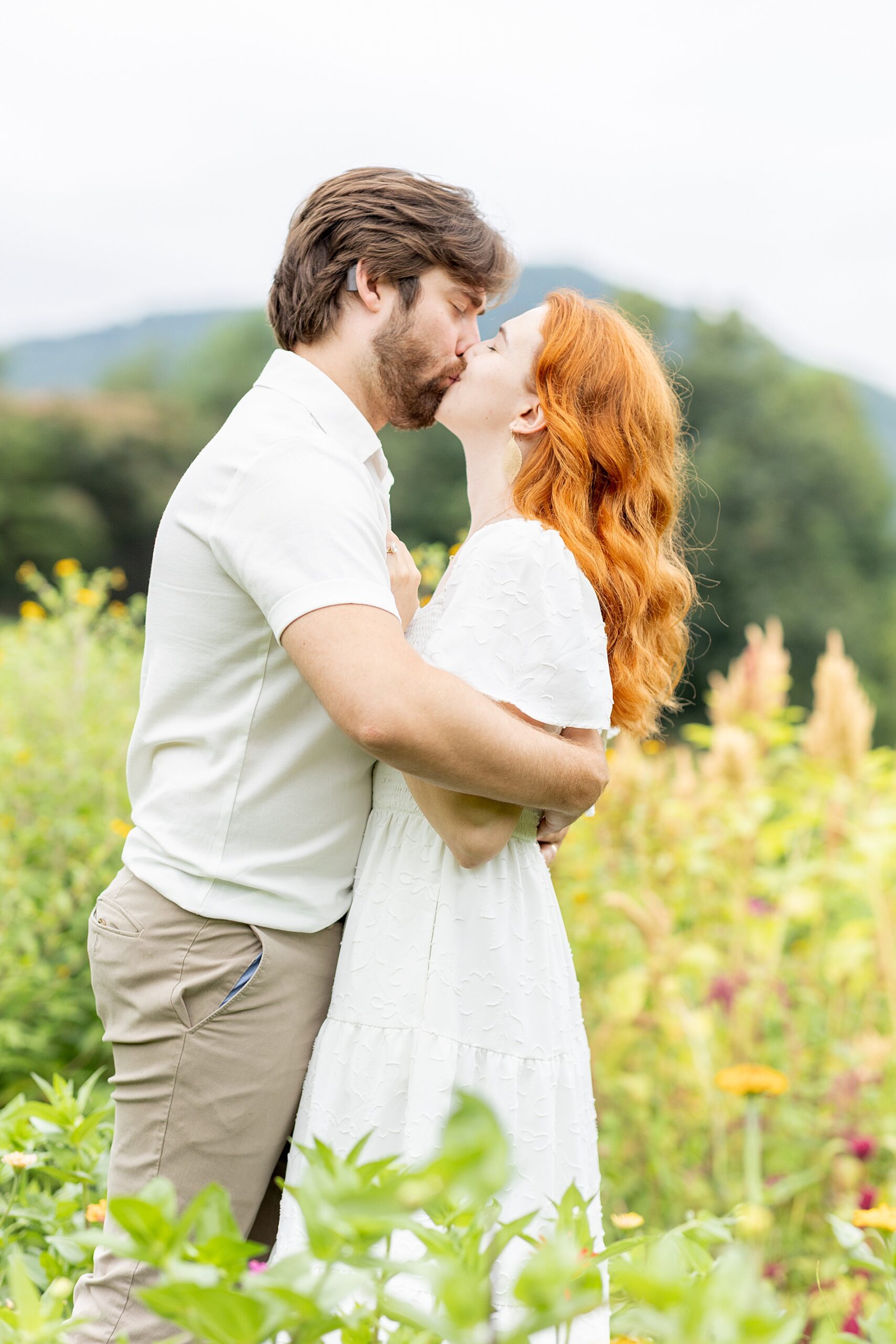 couple kiss in flower field