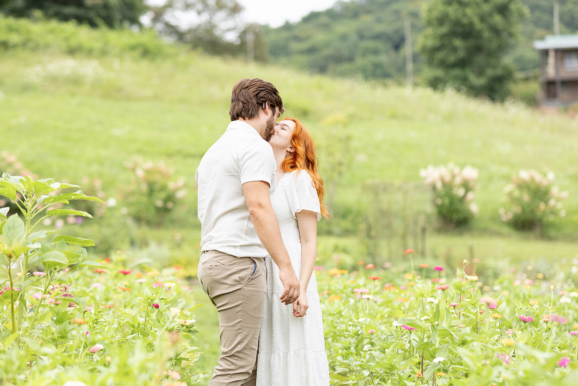 couple kiss in field of flowers