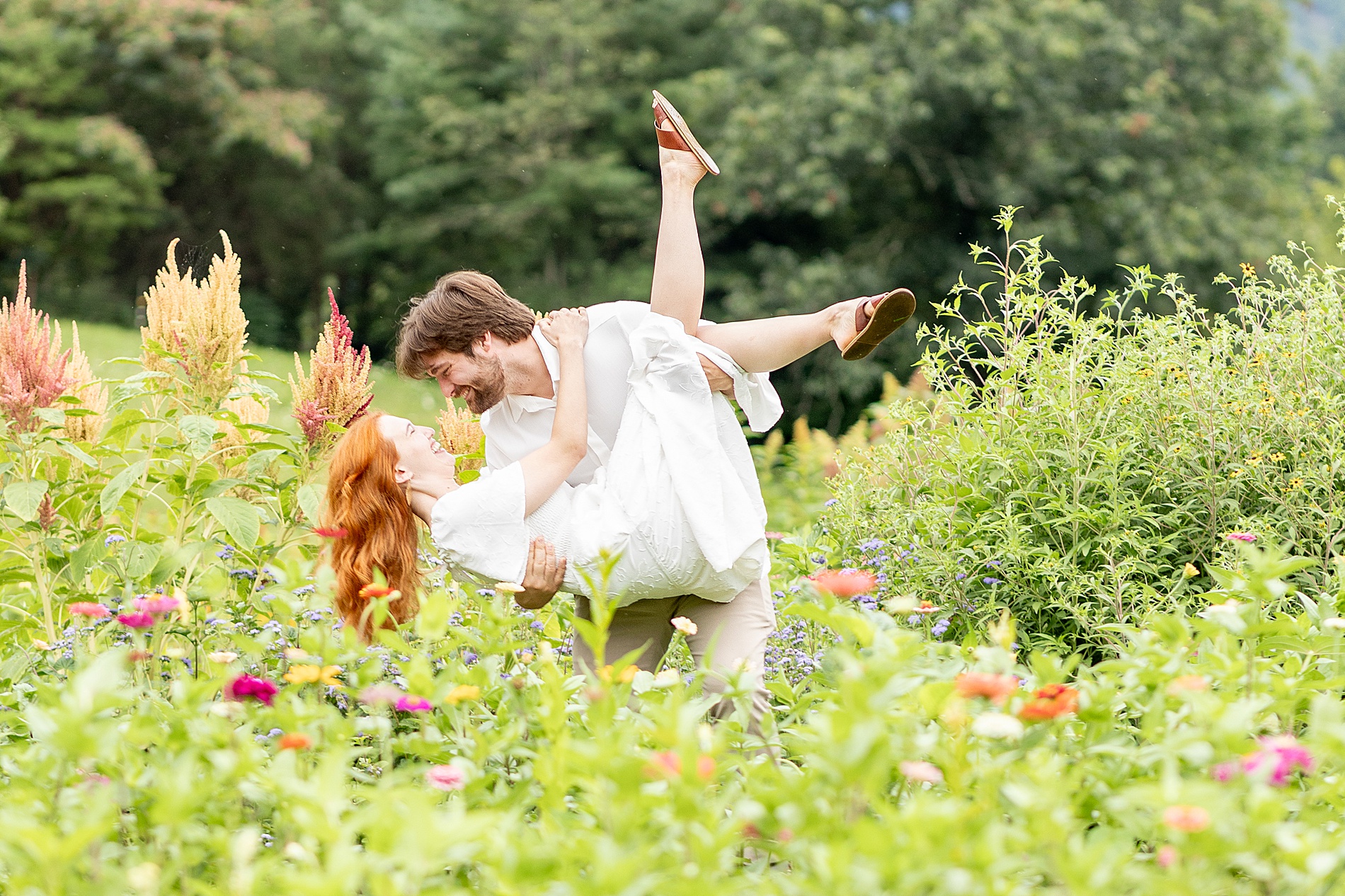 romantic couple portraits of man holding his wife in arms 