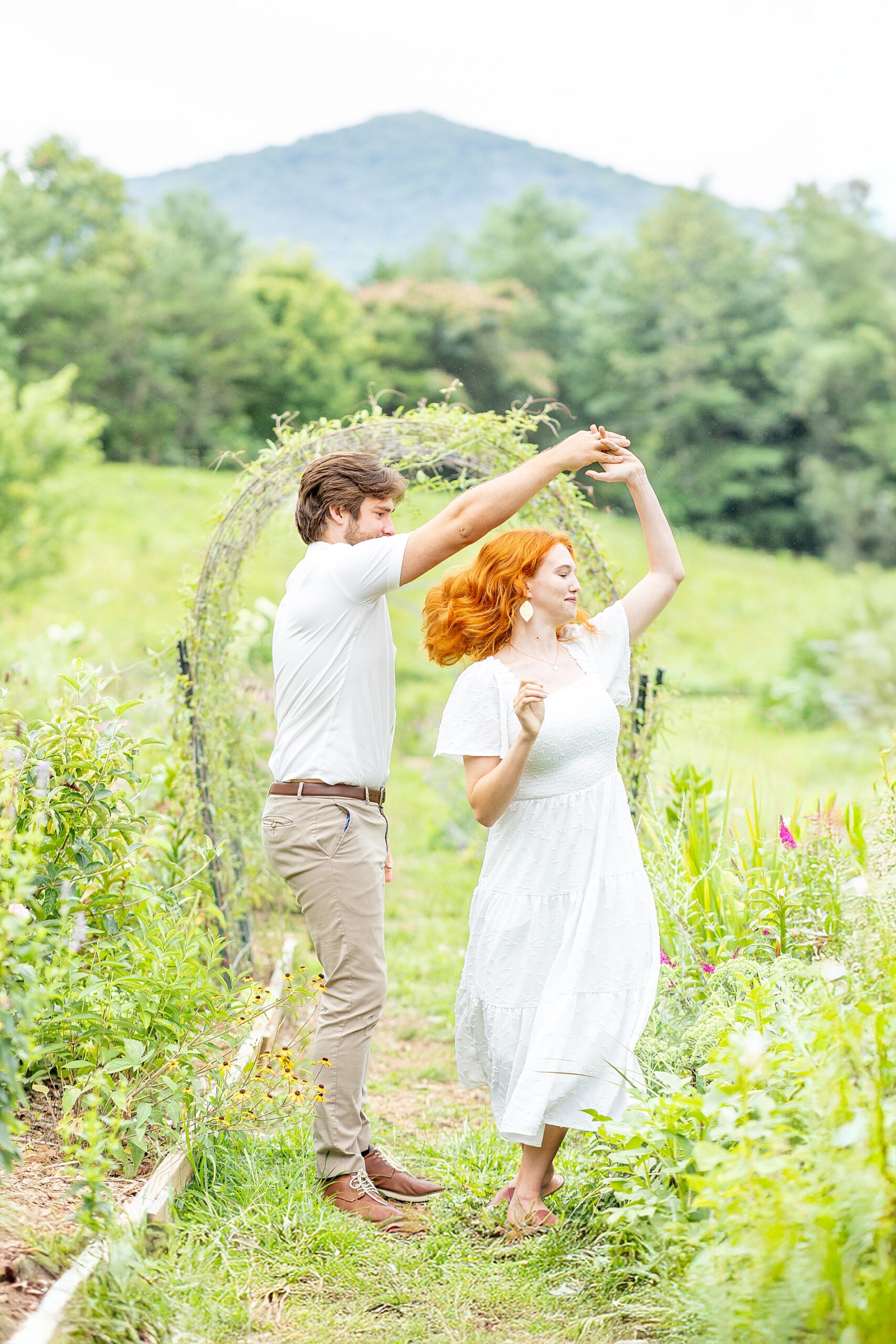 couple dance in flower field 