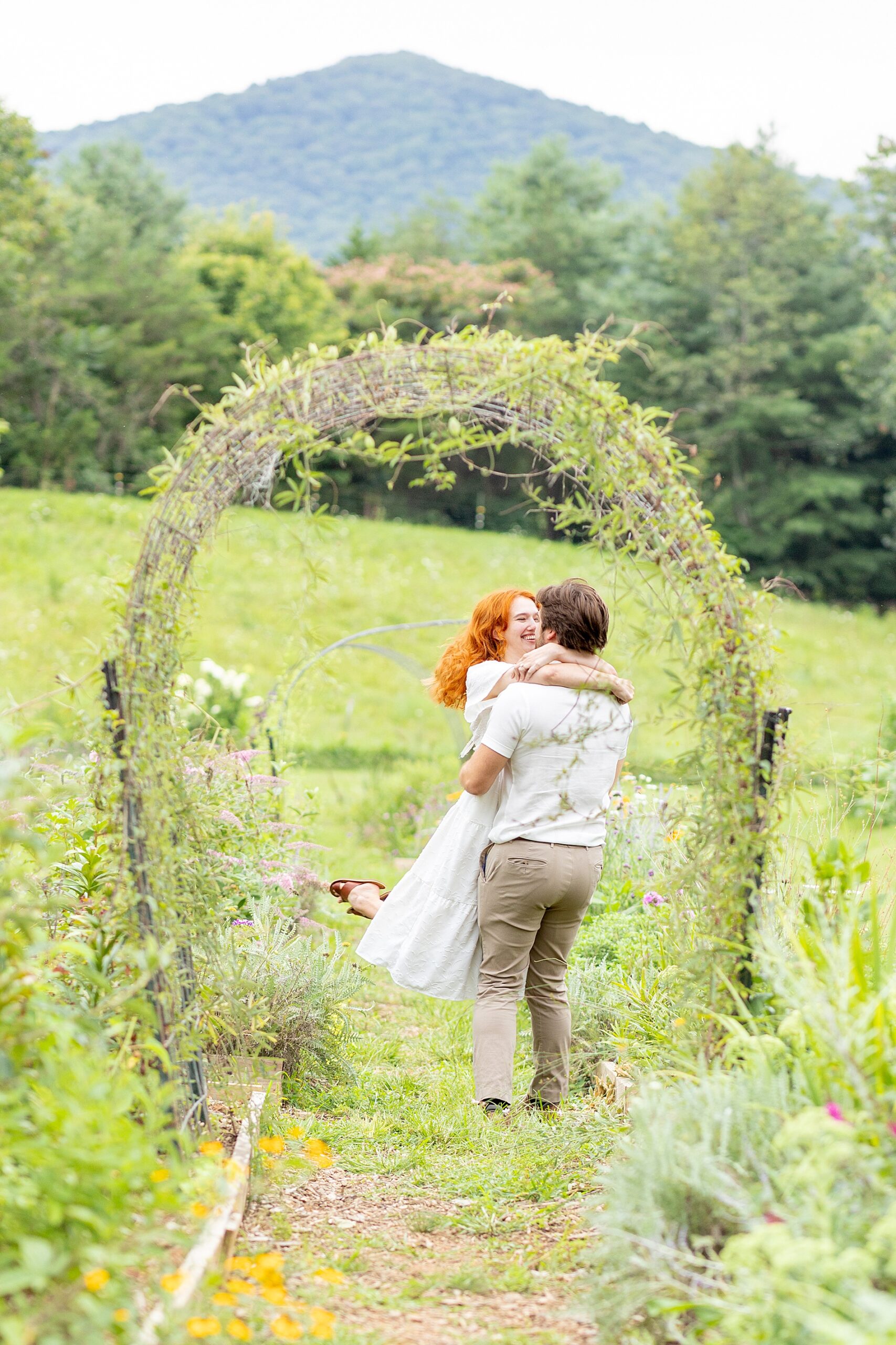 couple dances in path of flower field