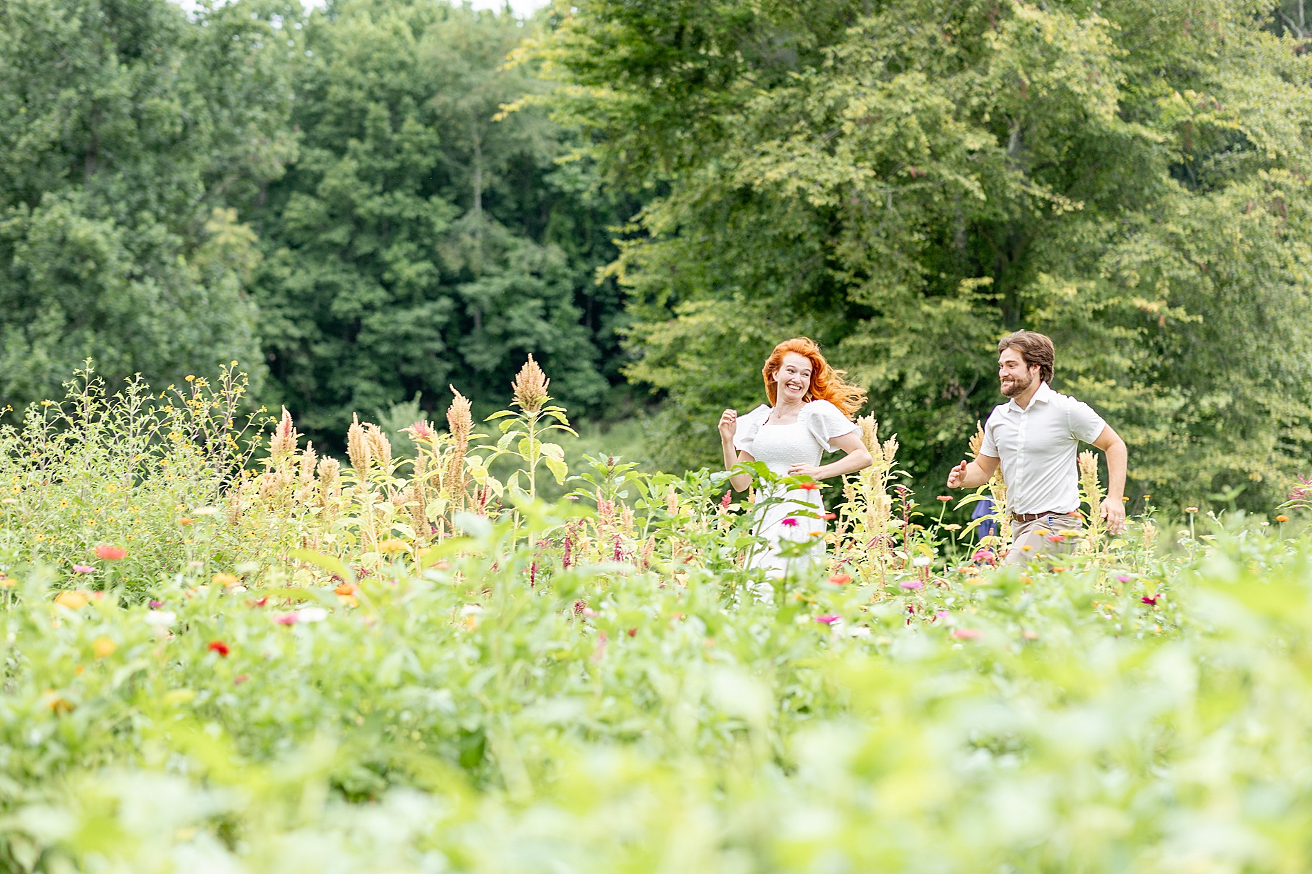 light and airy couple photos of them running through field of flowers