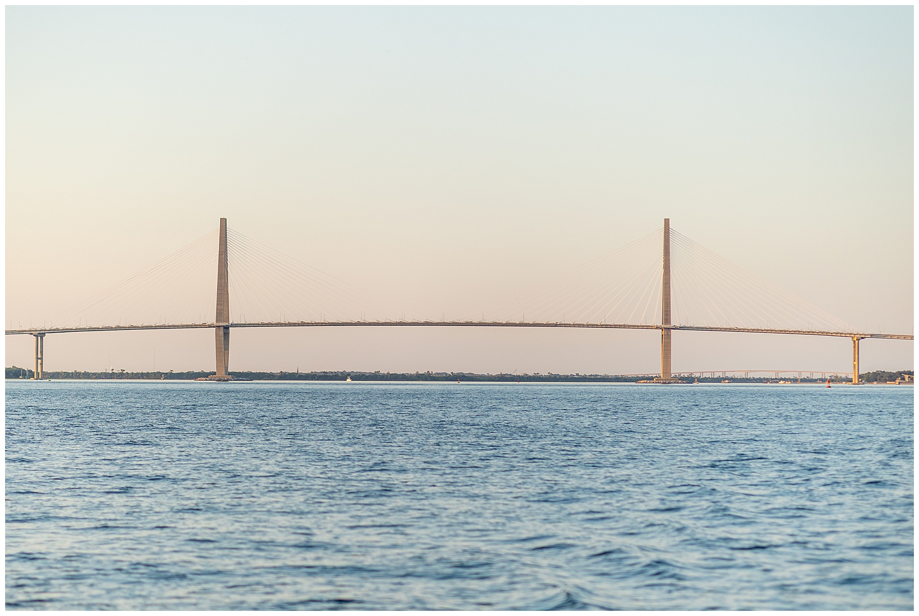 sun sets on the horizon over Charleston Harbor 
