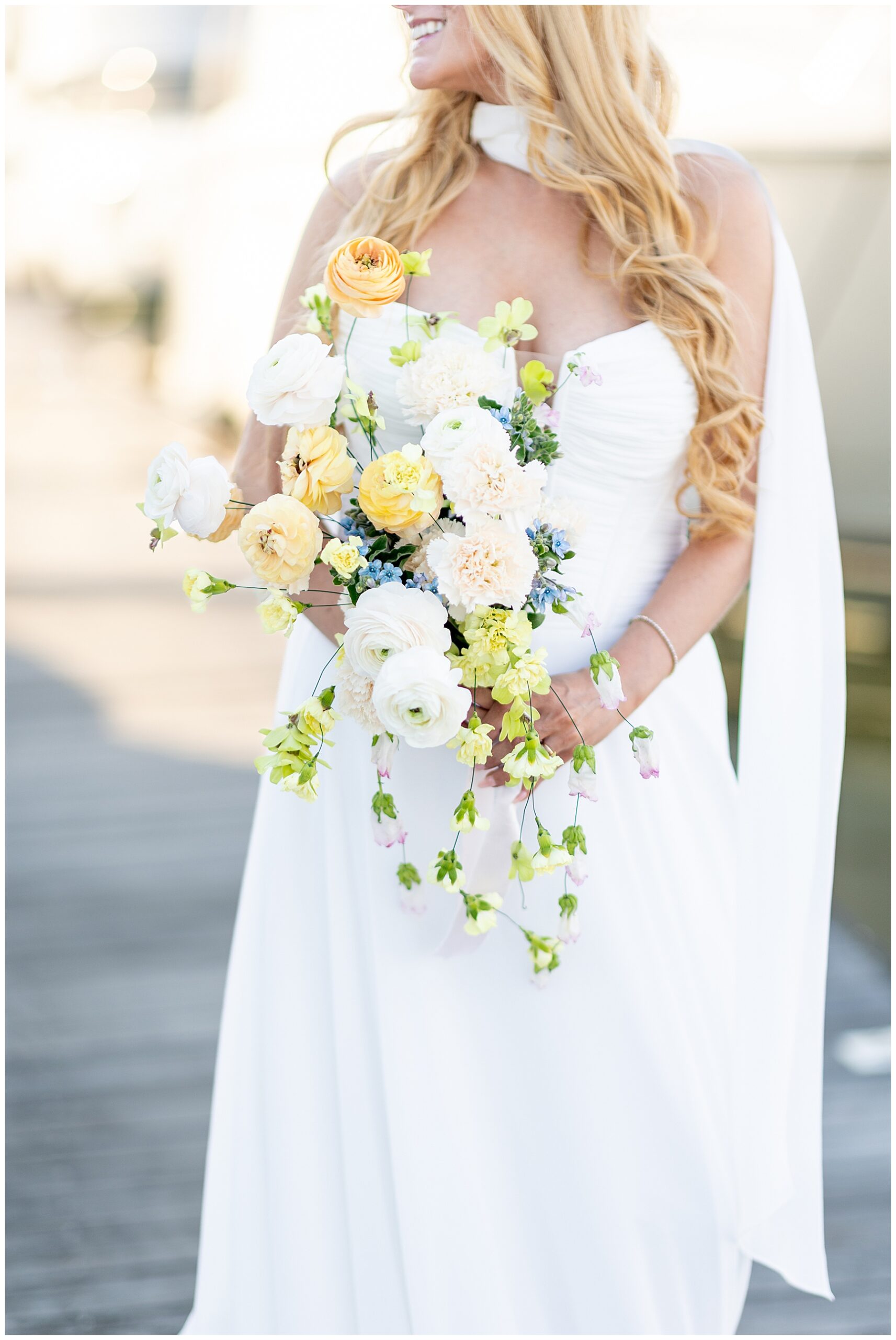 organic florals of bridal bouquet in soft yellow and white with greenery
