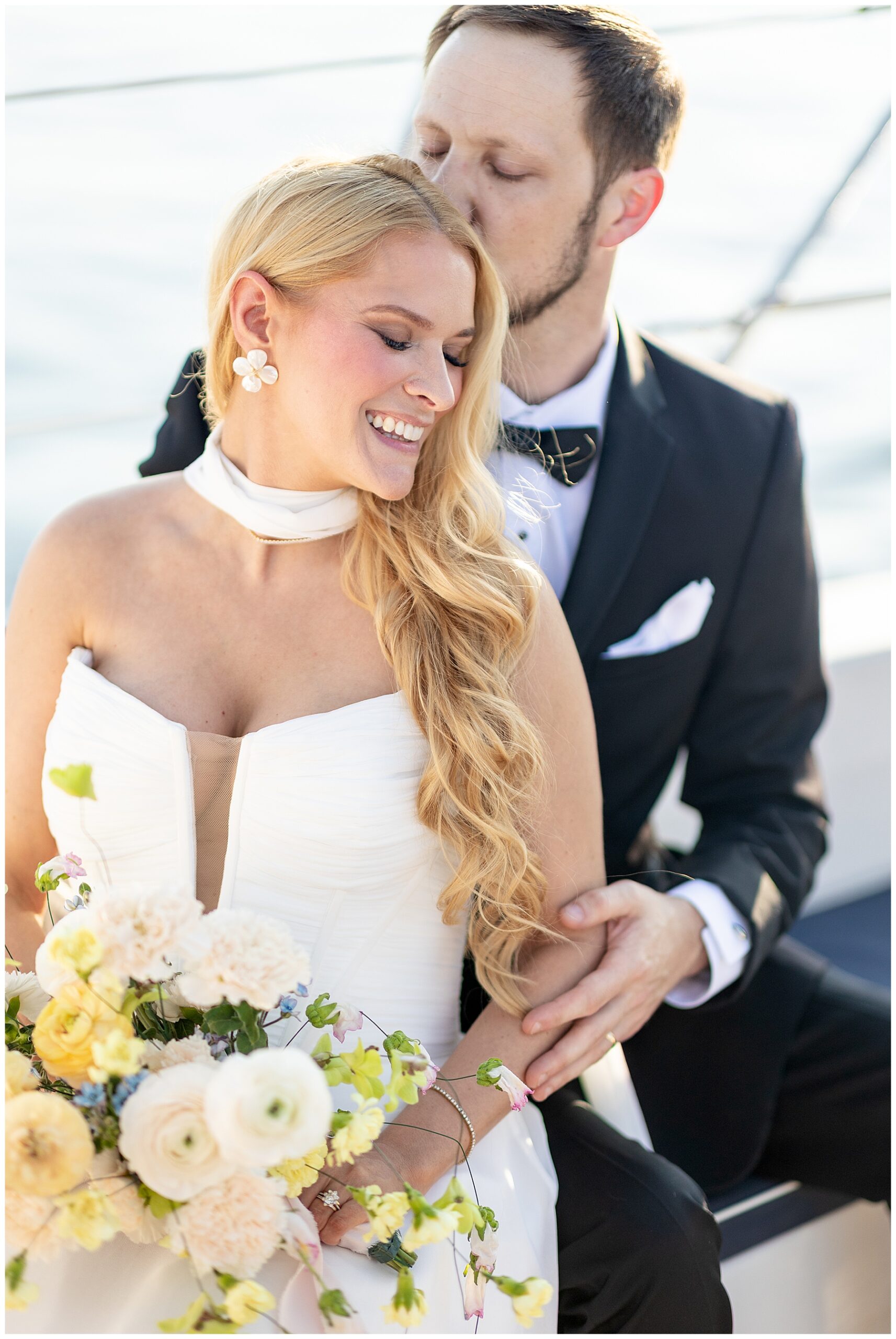 groom kisses bride's head
