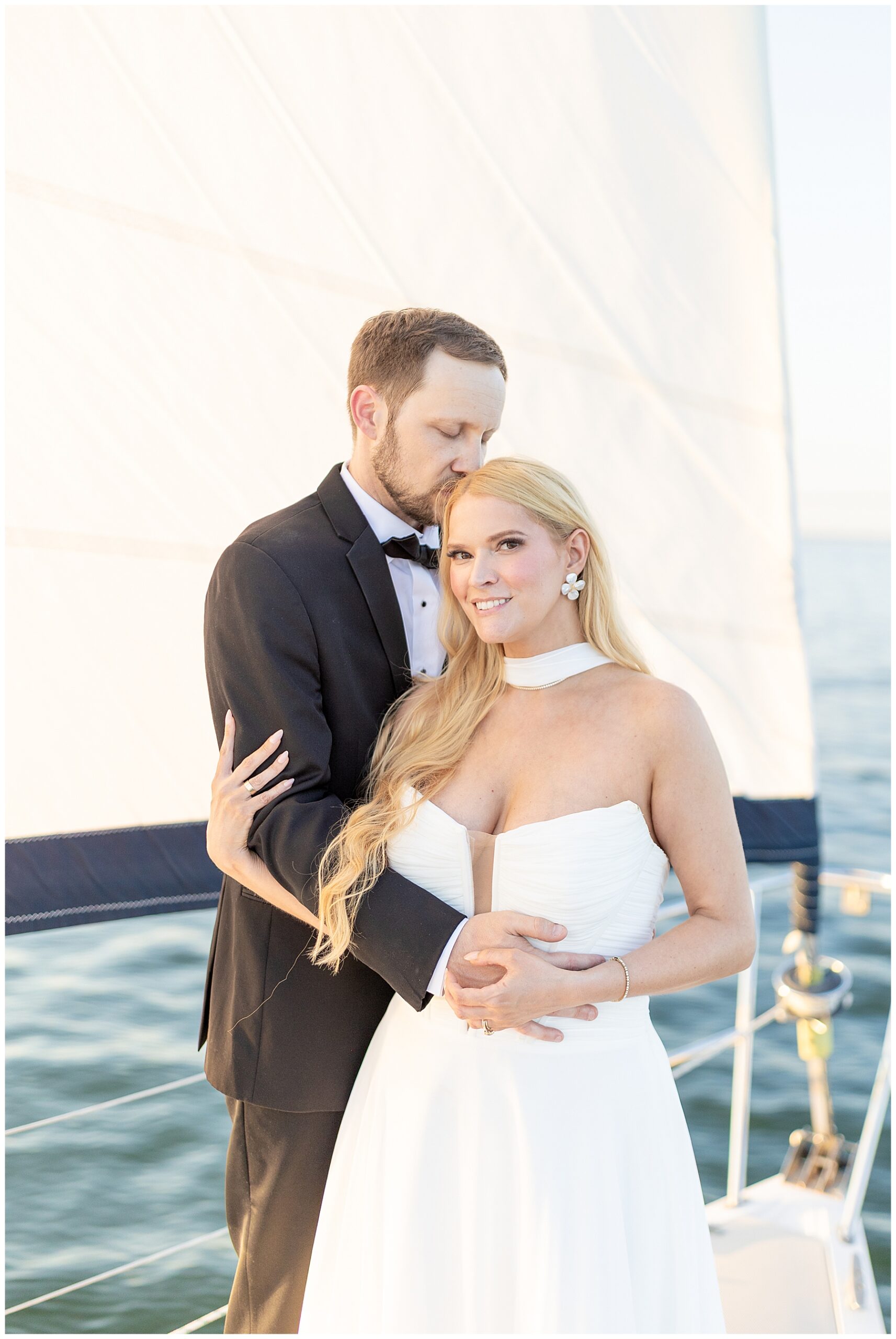 groom kisses bride's head