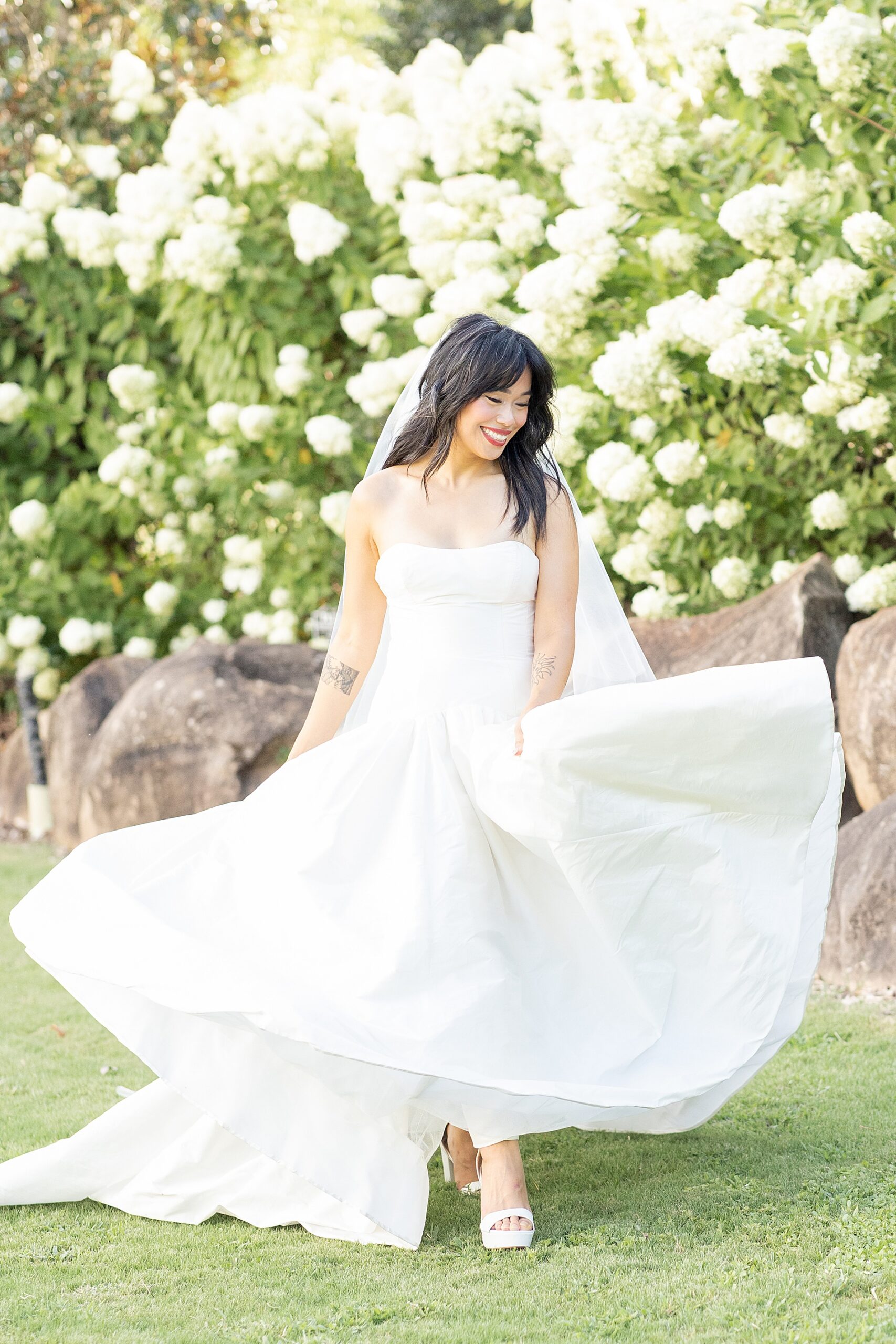 bride twirls dress in lawn of Heyward Manor  
