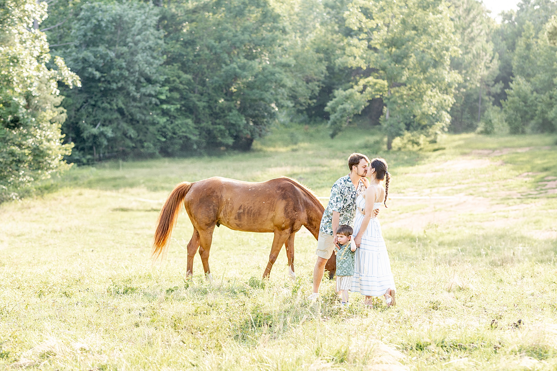 family by horse in farm field