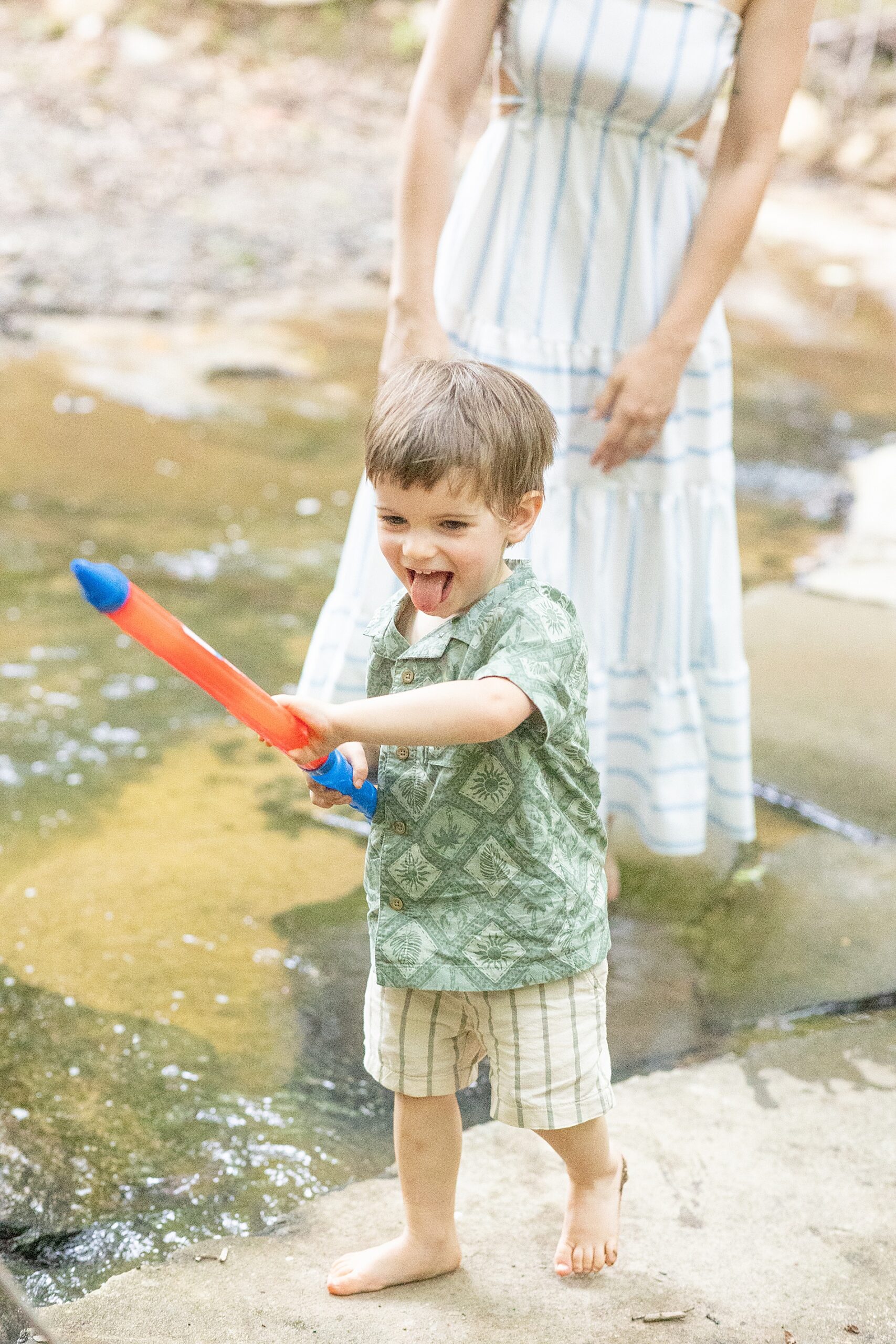 little boy playing in the creek