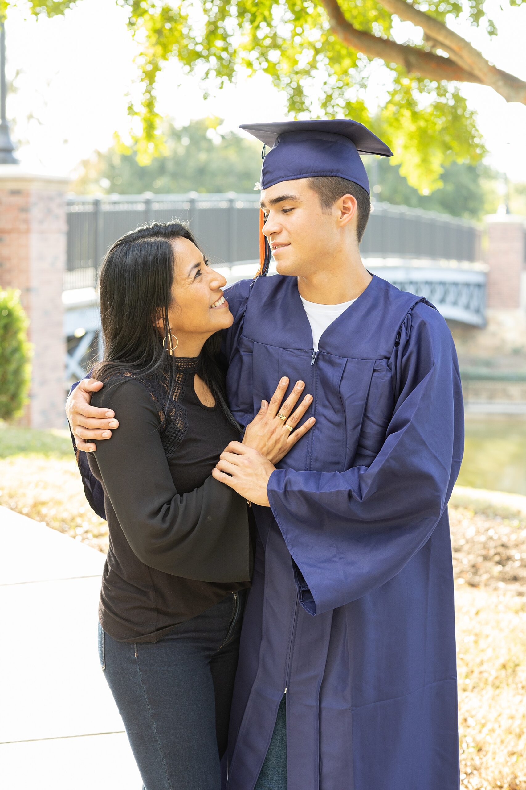 senior in cap and gown with his mom
