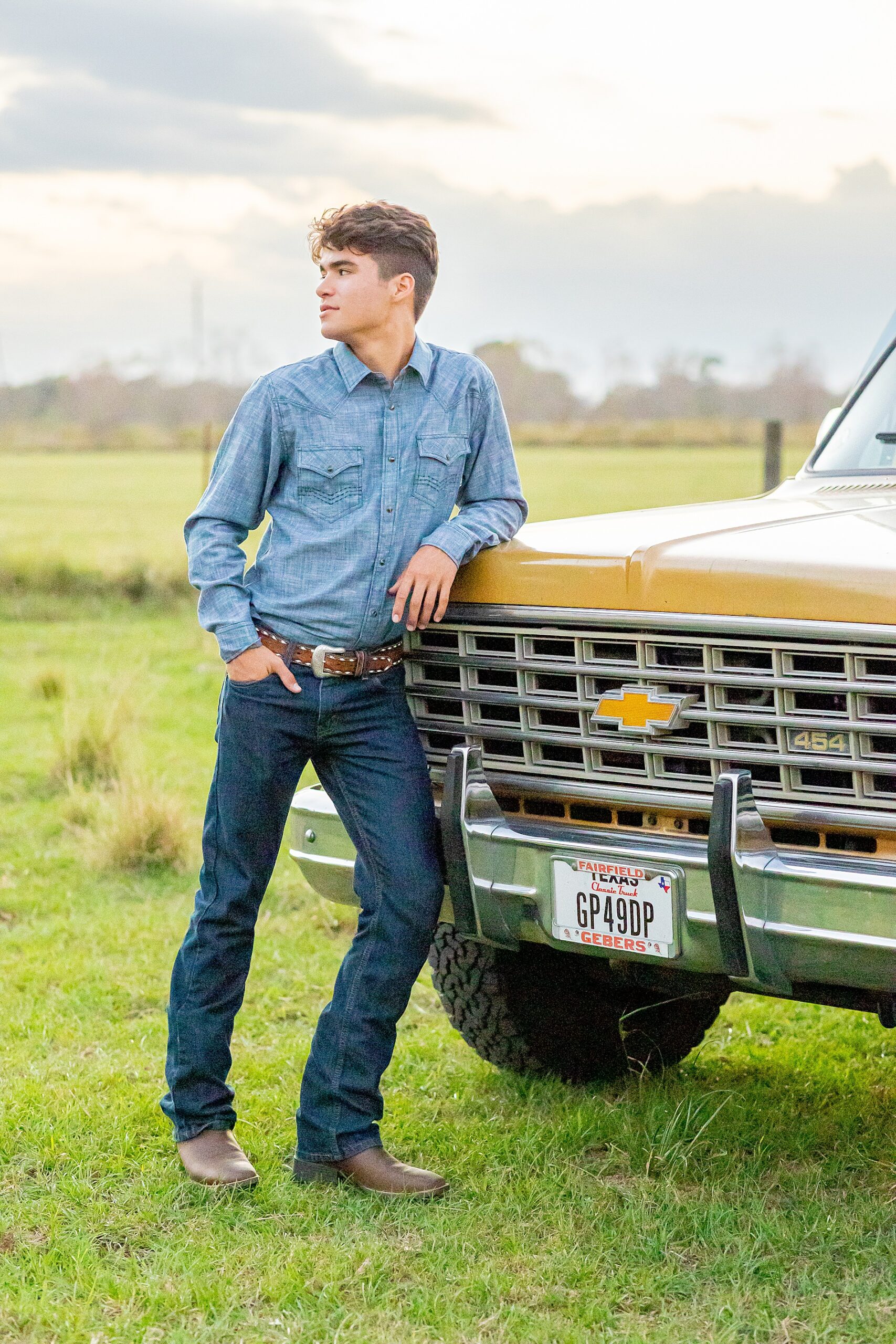 senior leans against truck 