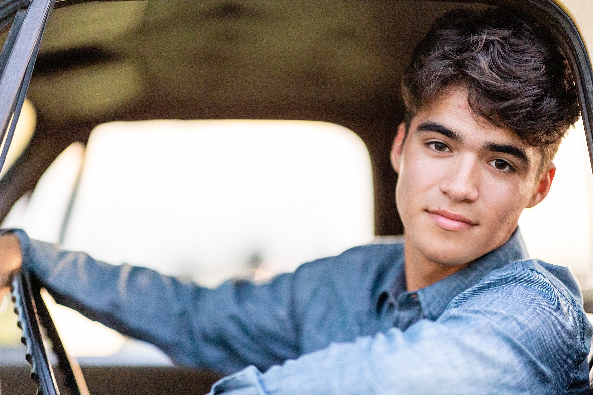 senior sits in his old truck