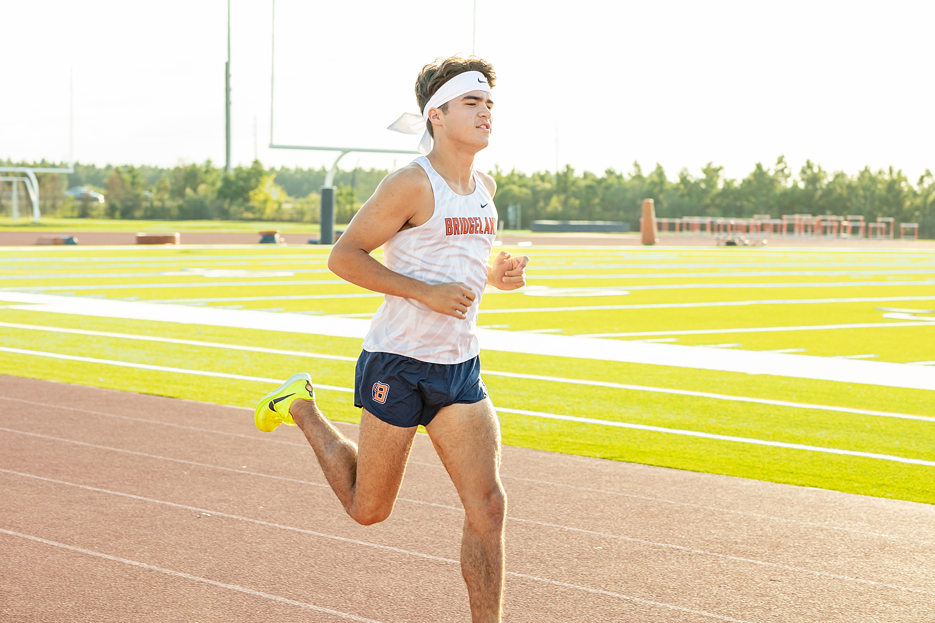 senior boy runs at local track in Houston 