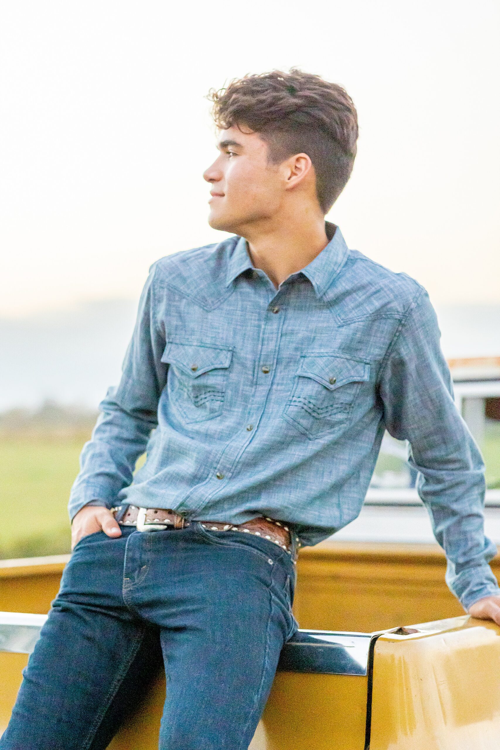 senior leans against his old truck