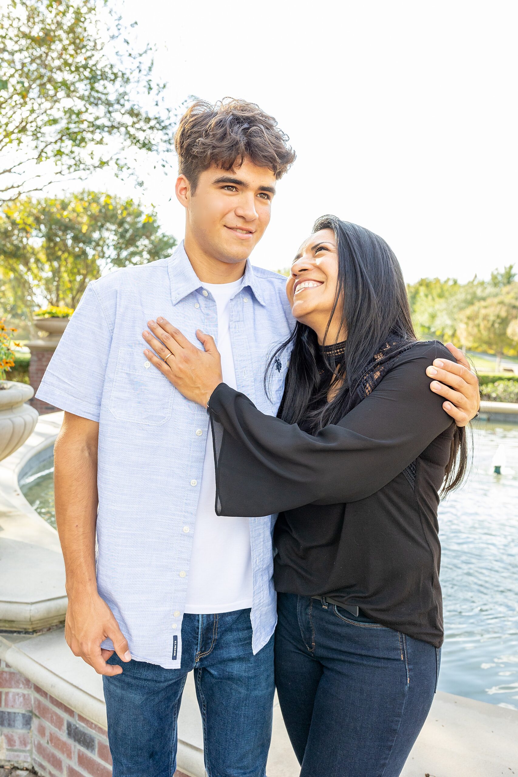 senior boy with mom during senior portrait session 