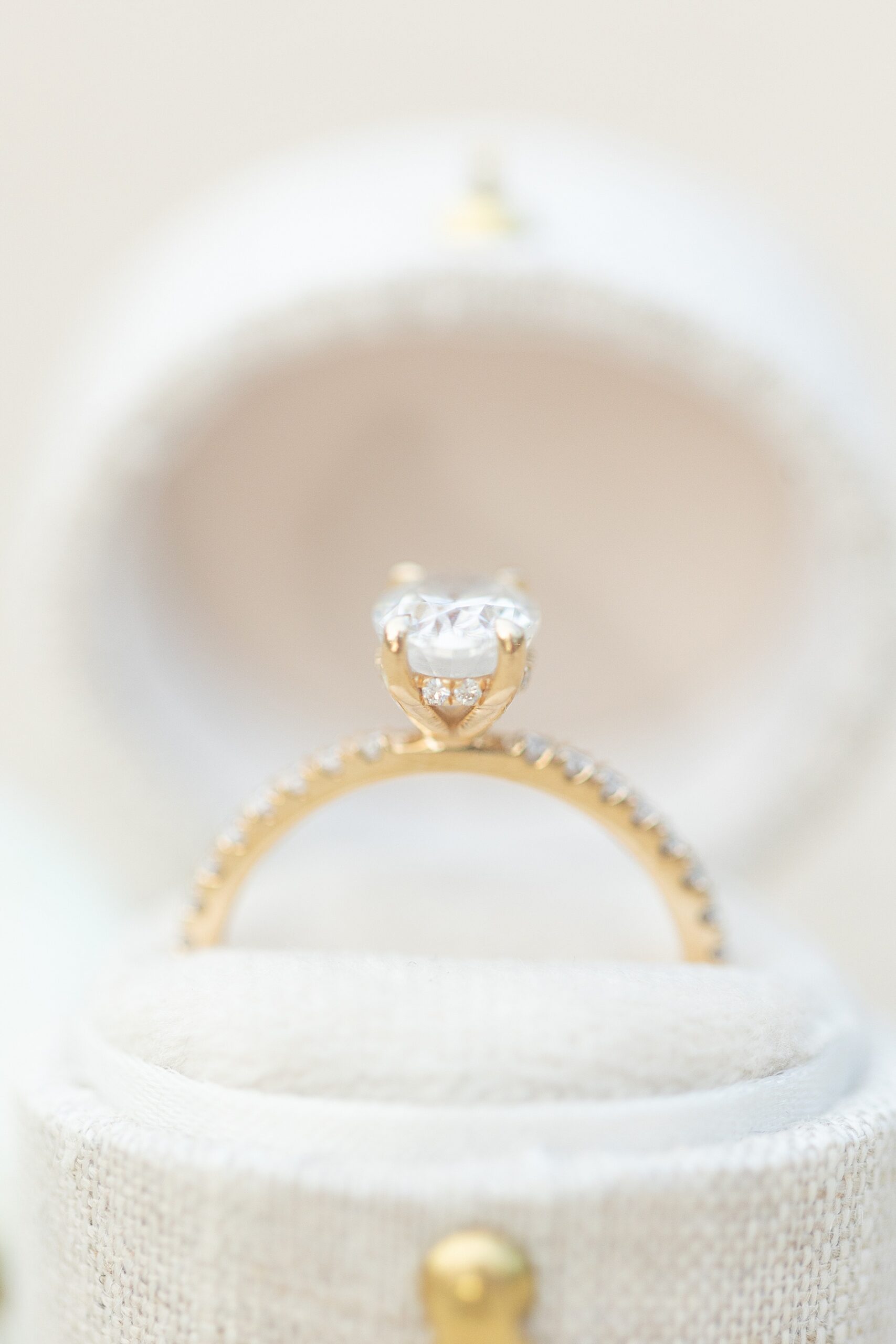 Gold engagement ring in white ring box