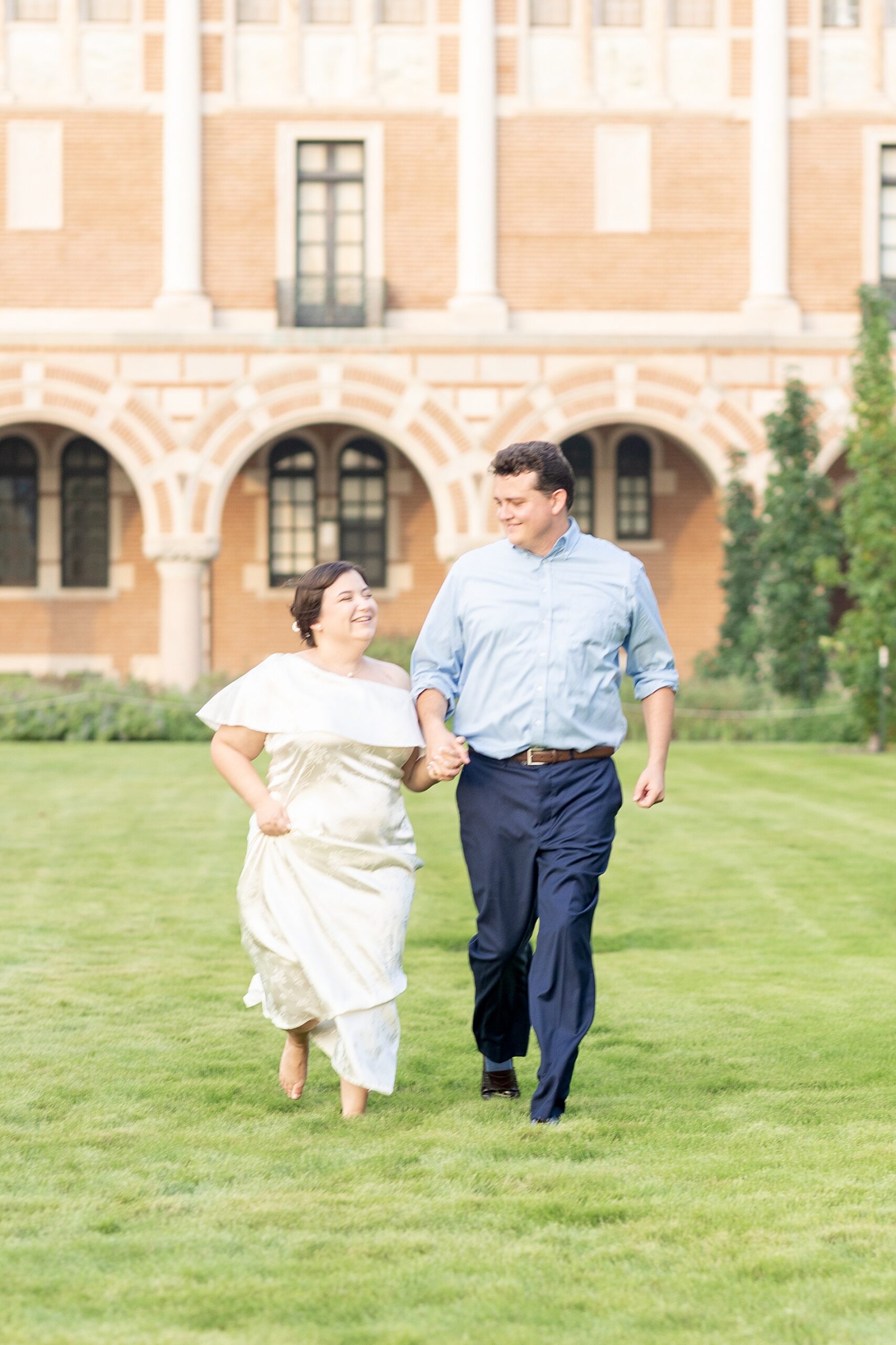 couple walk across the lawn at Rice University