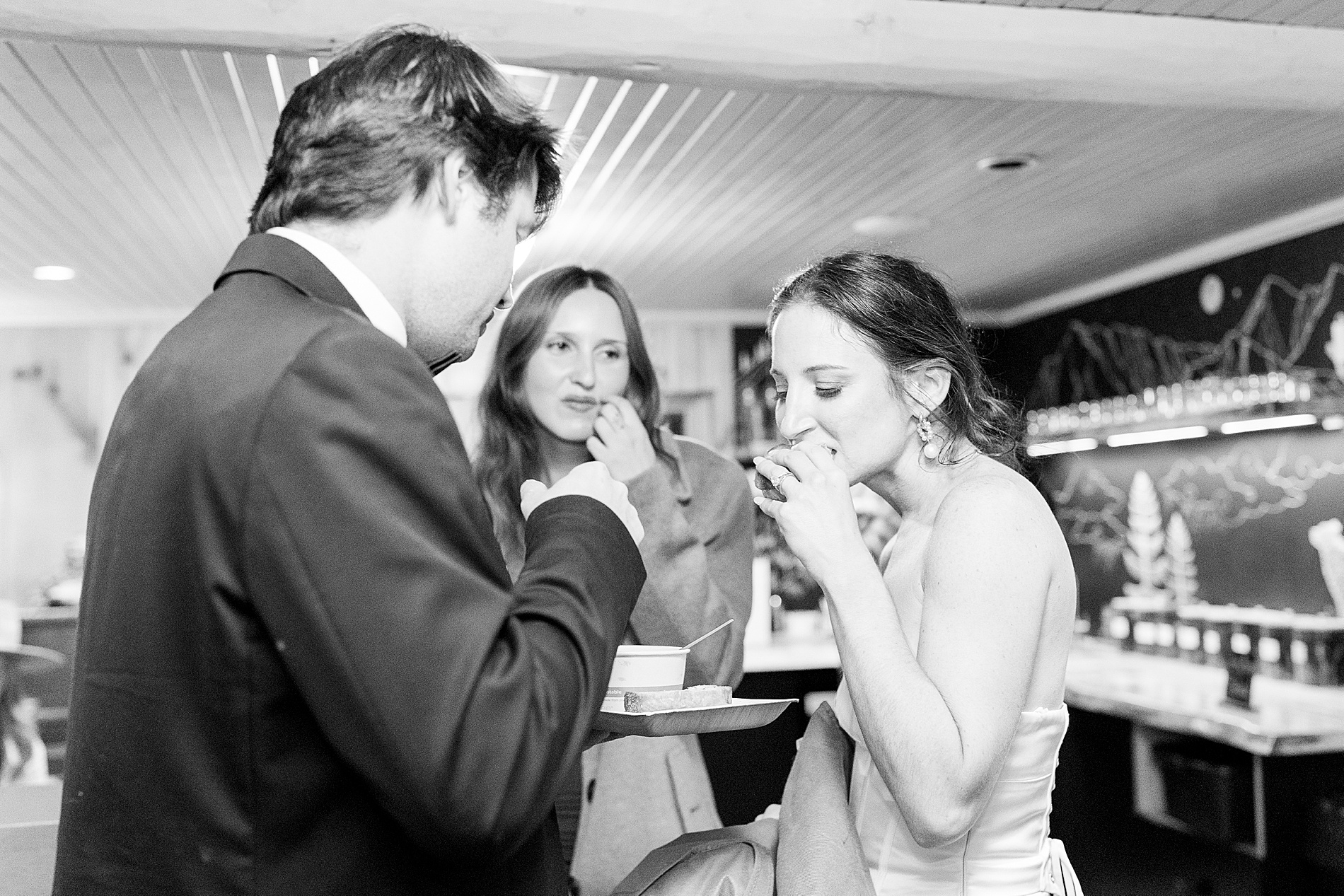 bride and groom eat a snack at wedding reception