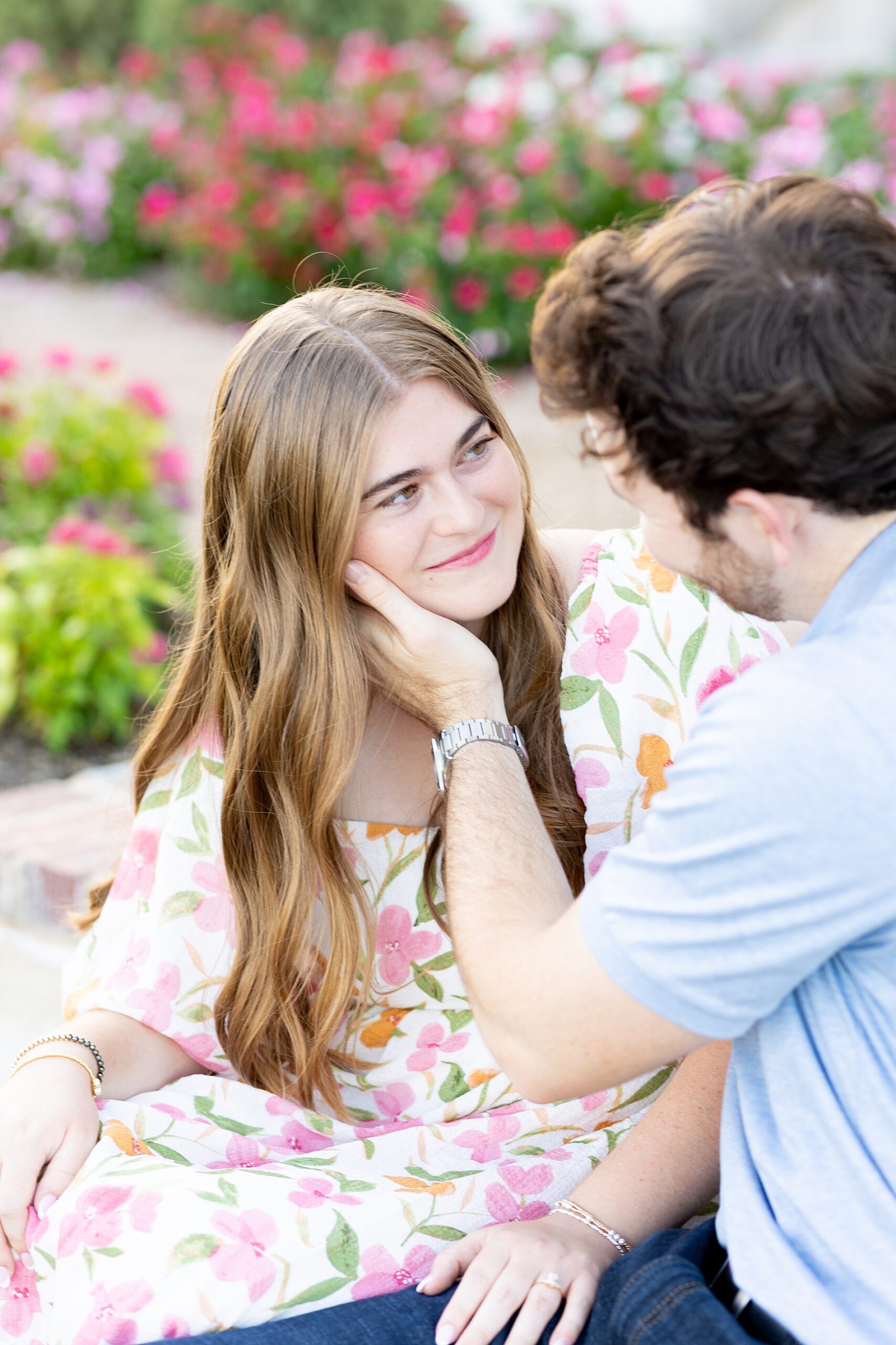 guy cradles woman's head in his hand 